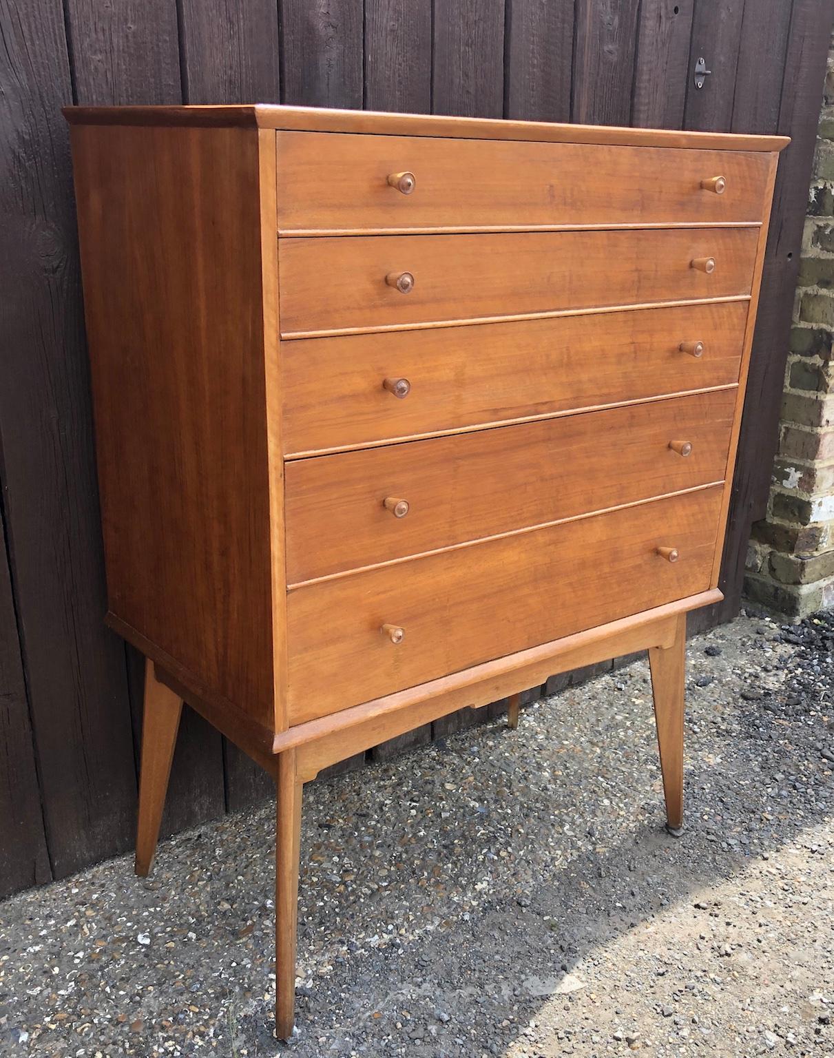 Midcentury teak and walnut chest of drawers on legs, tallboy by Alfred Cox for Heals, 1950s

Beautiful teak and walnut chest of drawers / tallboy designed by Alfred Cox for AC handcraft and retailed through Heals London during the 1950s.
This