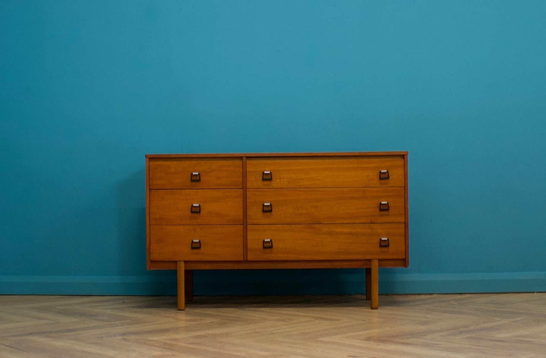 A teak chest of drawers from Symbol, Circa 1960s

It is long and low - so it can be used as a compact sideboard or TV unit

Featuring six drawers for plenty of storage

The matching dressing chest is available on a separate listing - they can be