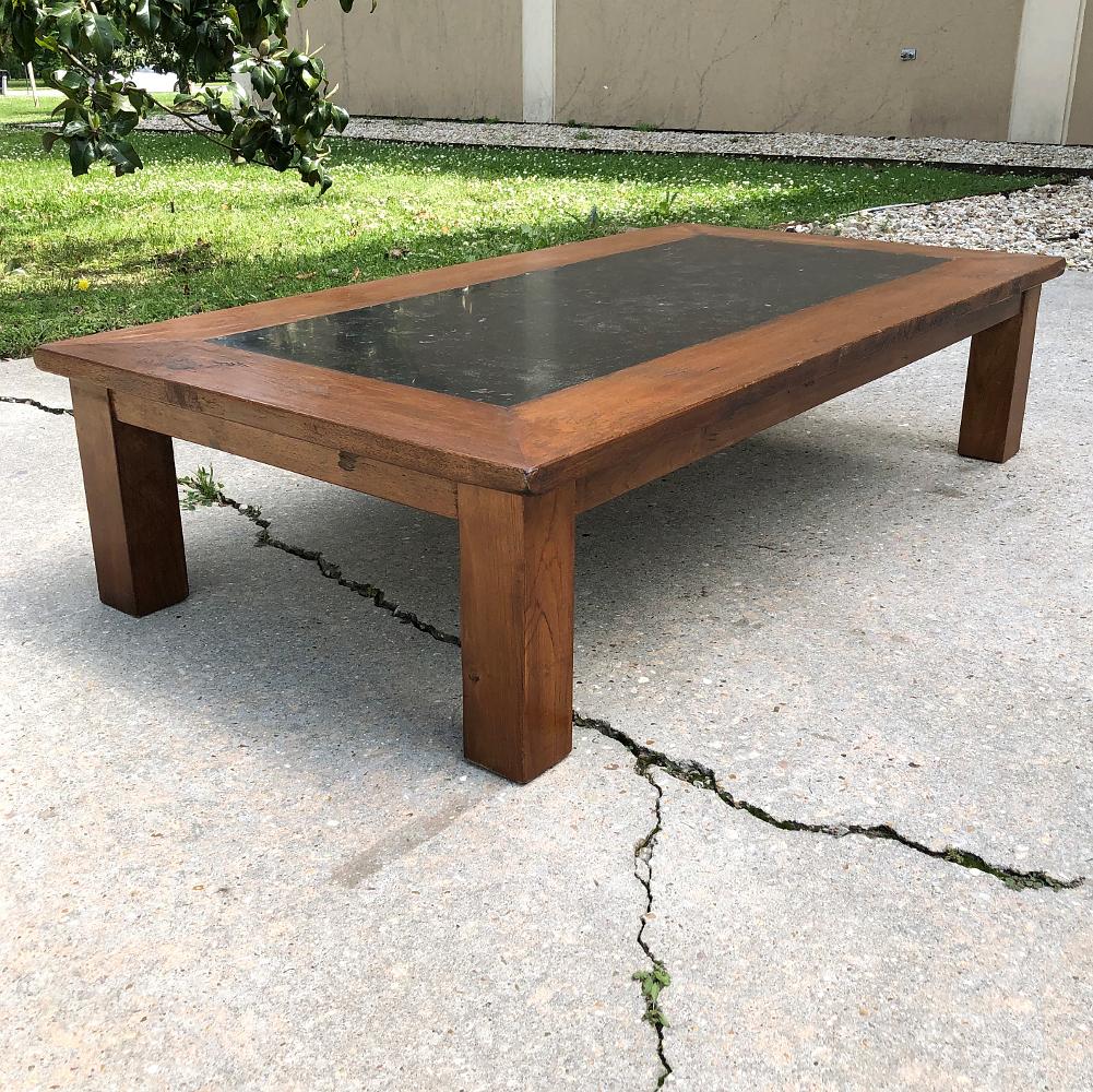 Mid-century chestnut black marble top coffee table was fashioned from thick planks and timbers of old-growth, well-seasoned chestnut, providing a remarkably naturalistic and charming wood grain appearance on the legs, apron and framework around the
