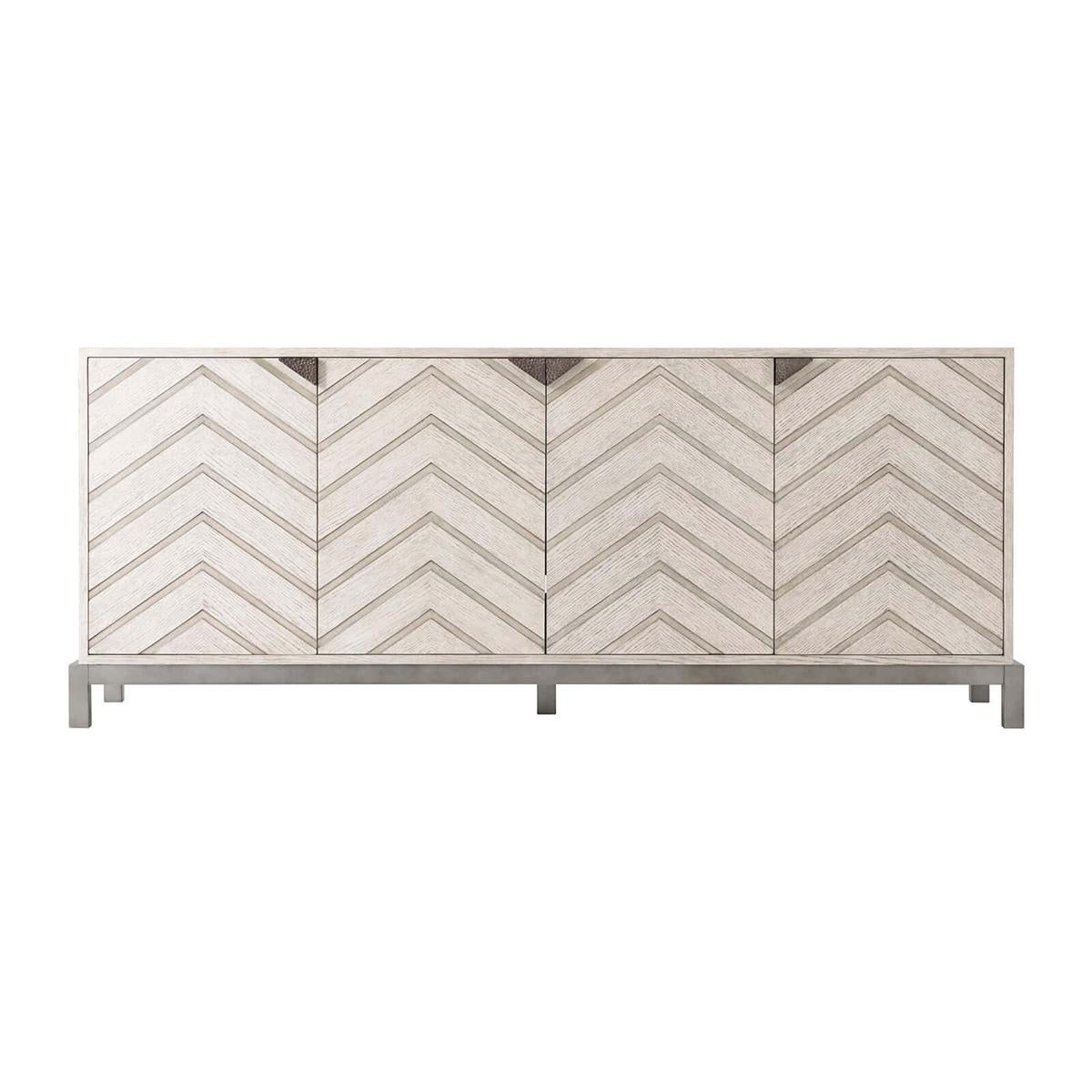 Mid Century Chevron Sideboard in our light Gowan finish, with a rectangular quartered oak centered top, four chevron pattern relief paneled doors, and triangular hammered metal handles on a matte tungsten finish base. Fitted with three interior