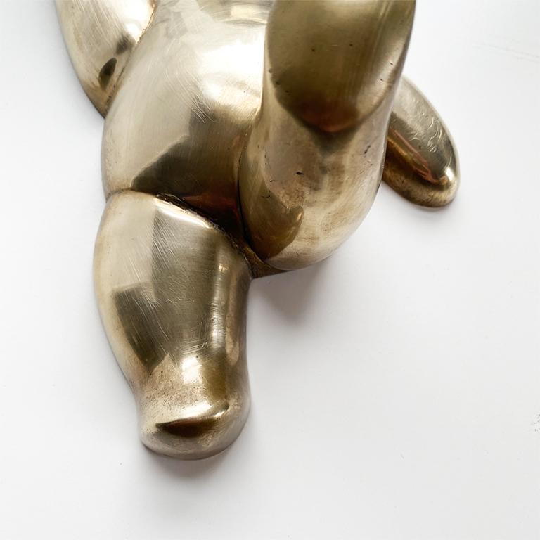 A brass bear hook that will be the perfect addition to any child's room or nursery. This piece is created from brass and includes hanging hardware at the back. The hook depicts a teddy bear, with its leg raised for use as a hook to hang towels,