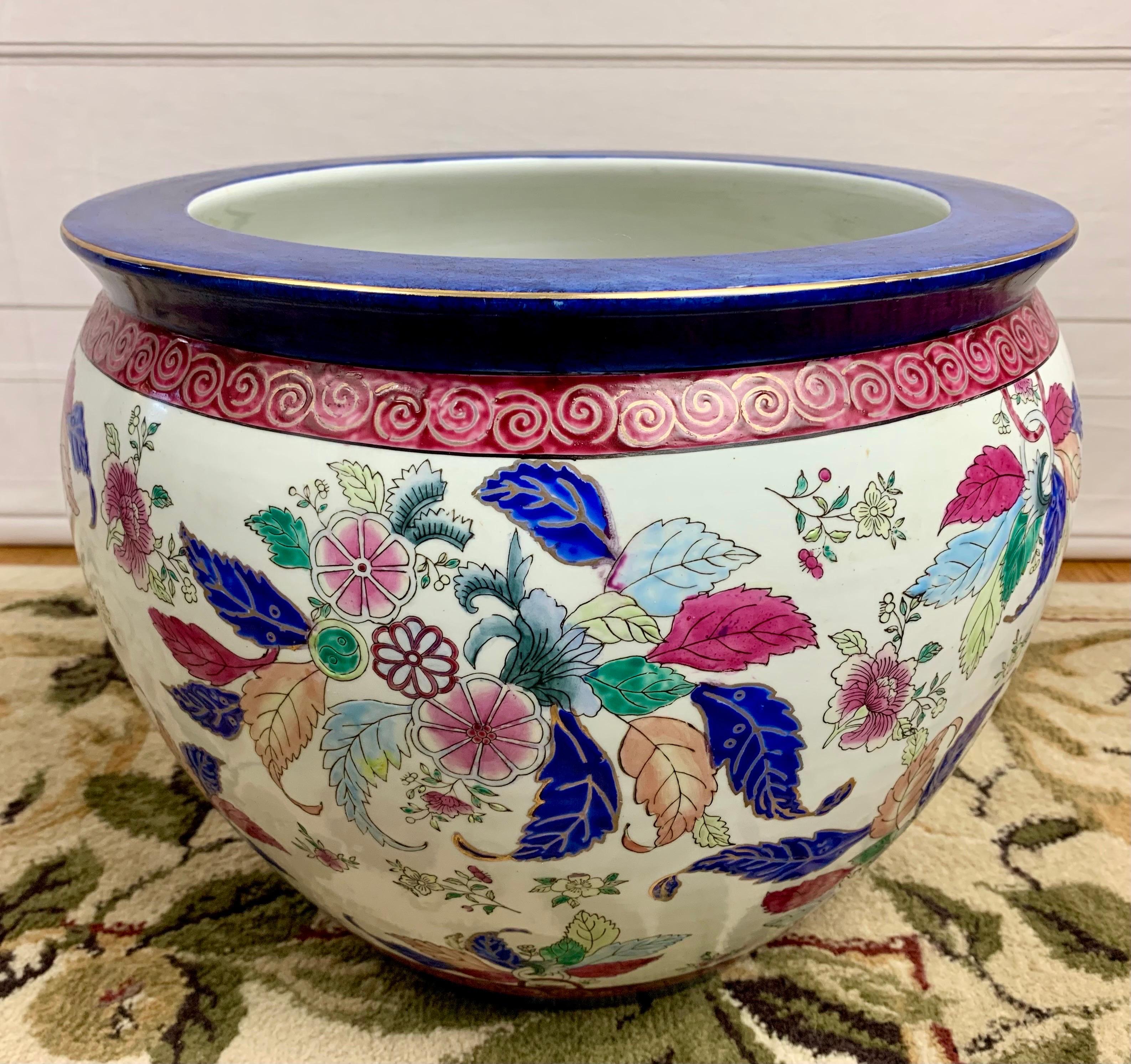 A beautiful chinoiserie fish bowl with a rich color palette featuring shades of blue, green, tan burgundy/mauve on a crisp white background. Fitted with a glass top (included) for versatility. 

Made in China circa 1940. 

Excellent condition with