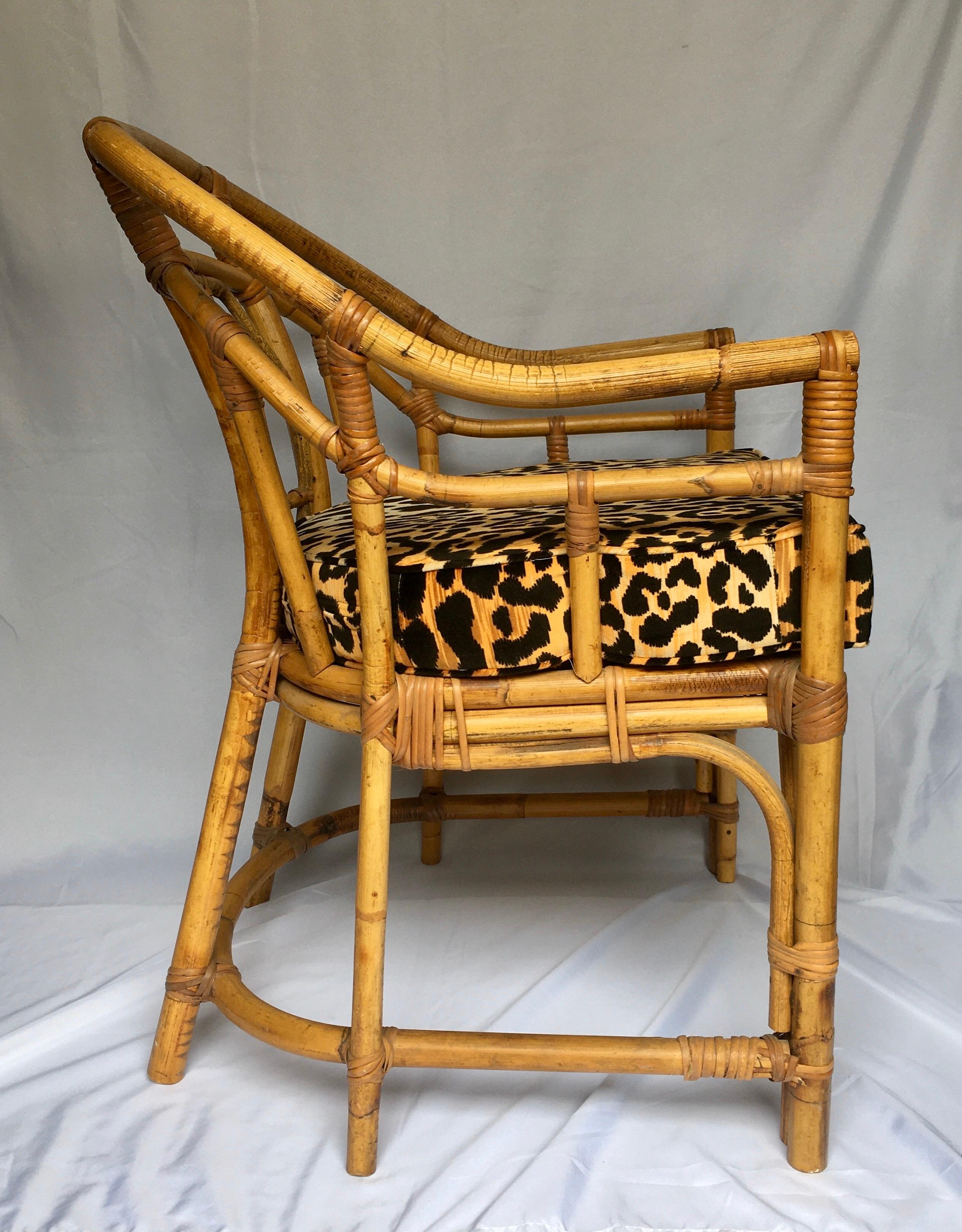 Midcentury Chinese Chippendale Brighton Pavilion style natural bamboo armchair. This chinoiserie style accent arm chair features a geometric fretwork design back and new custom animal print cotton velvet seat cushion. Would also make a beautiful