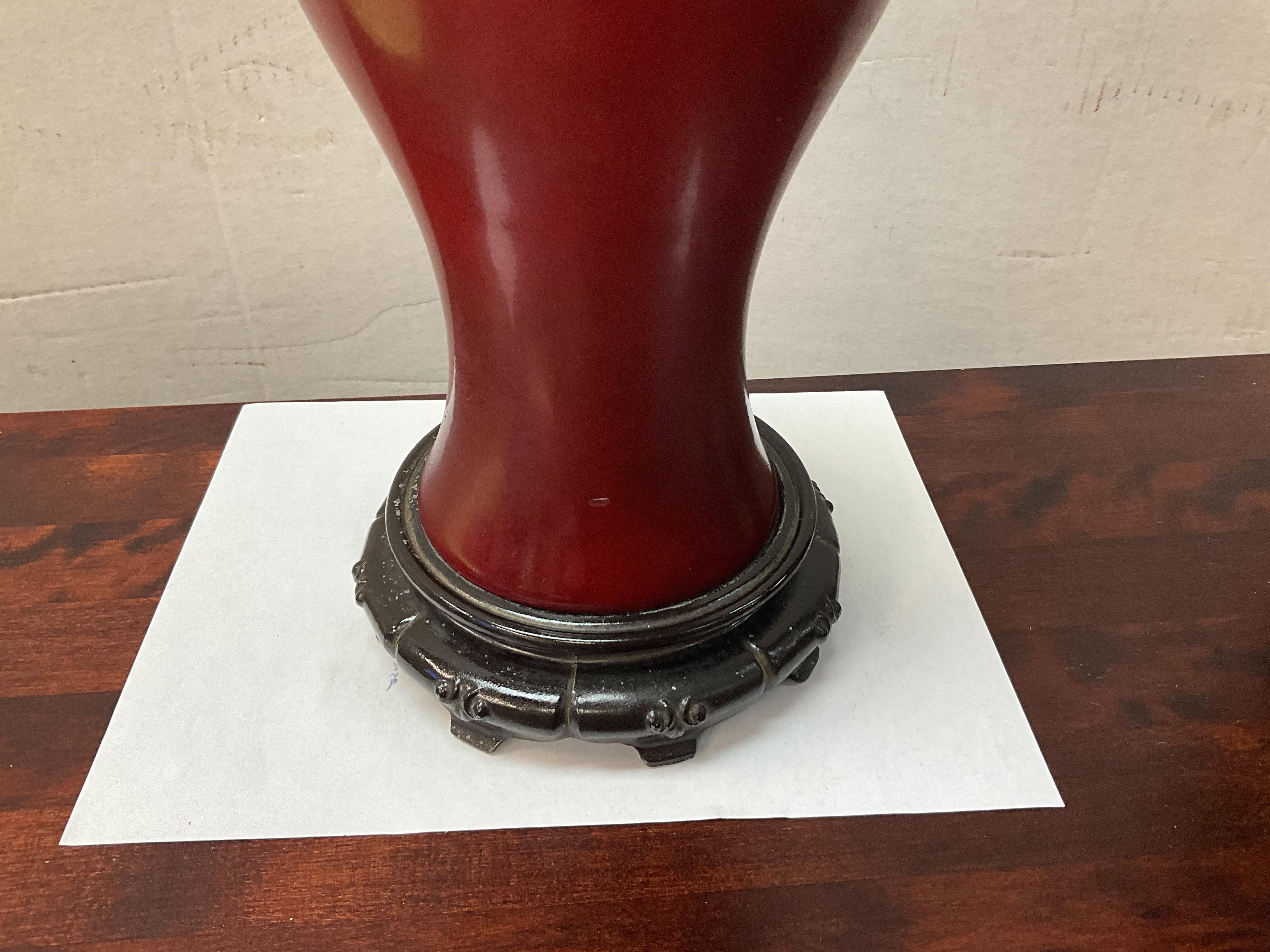 This is a pair of Chinese Export phoenix tail form oxblood red porcelain table lamps in very good condition. The wiring is vintage but in working order. 