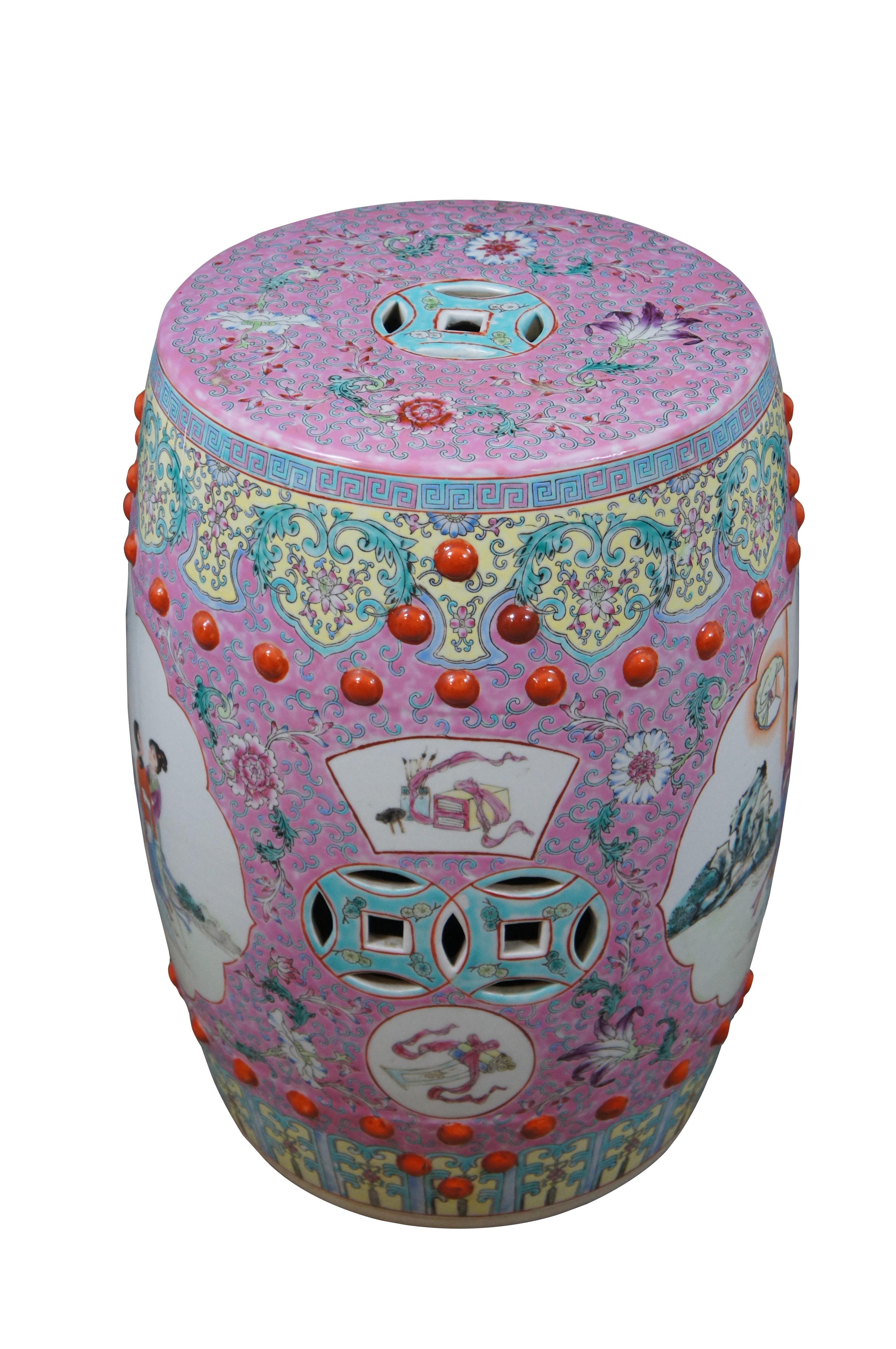Vintage Chinese Famille Rose bright colorful ceramic garden seat, stool or occasional side table. Features a round and oblong body with the overall shape tapering slightly at the top as well as the bottom. The top of the stool  features a pierced