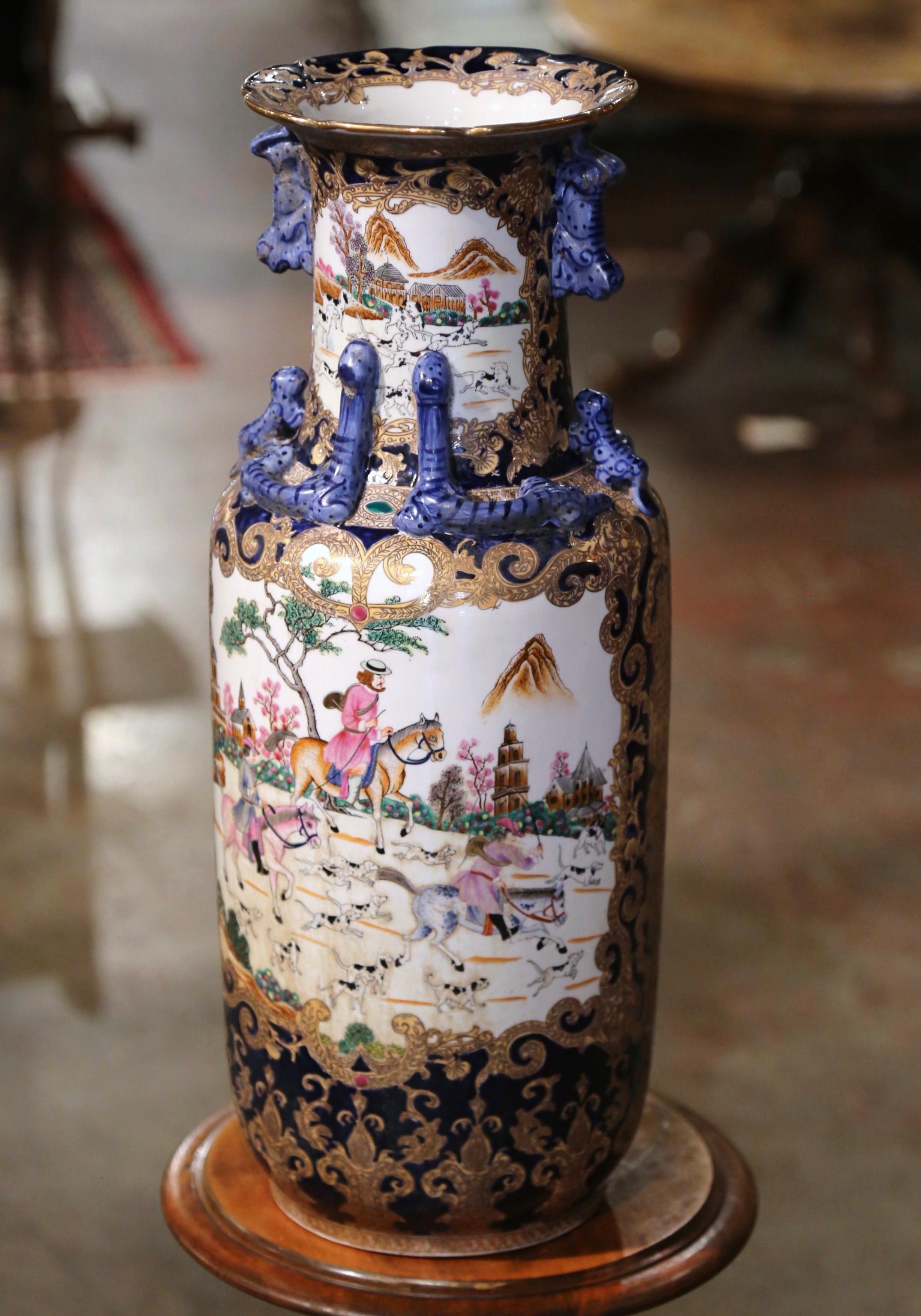 Decorate a table or a console with this colorful vintage porcelain vase. Created in China circa 1960, the large vessel with flared rim and tapered body, is decorated with lizard and foo dog motifs around the neck. The neck  boasts two charming