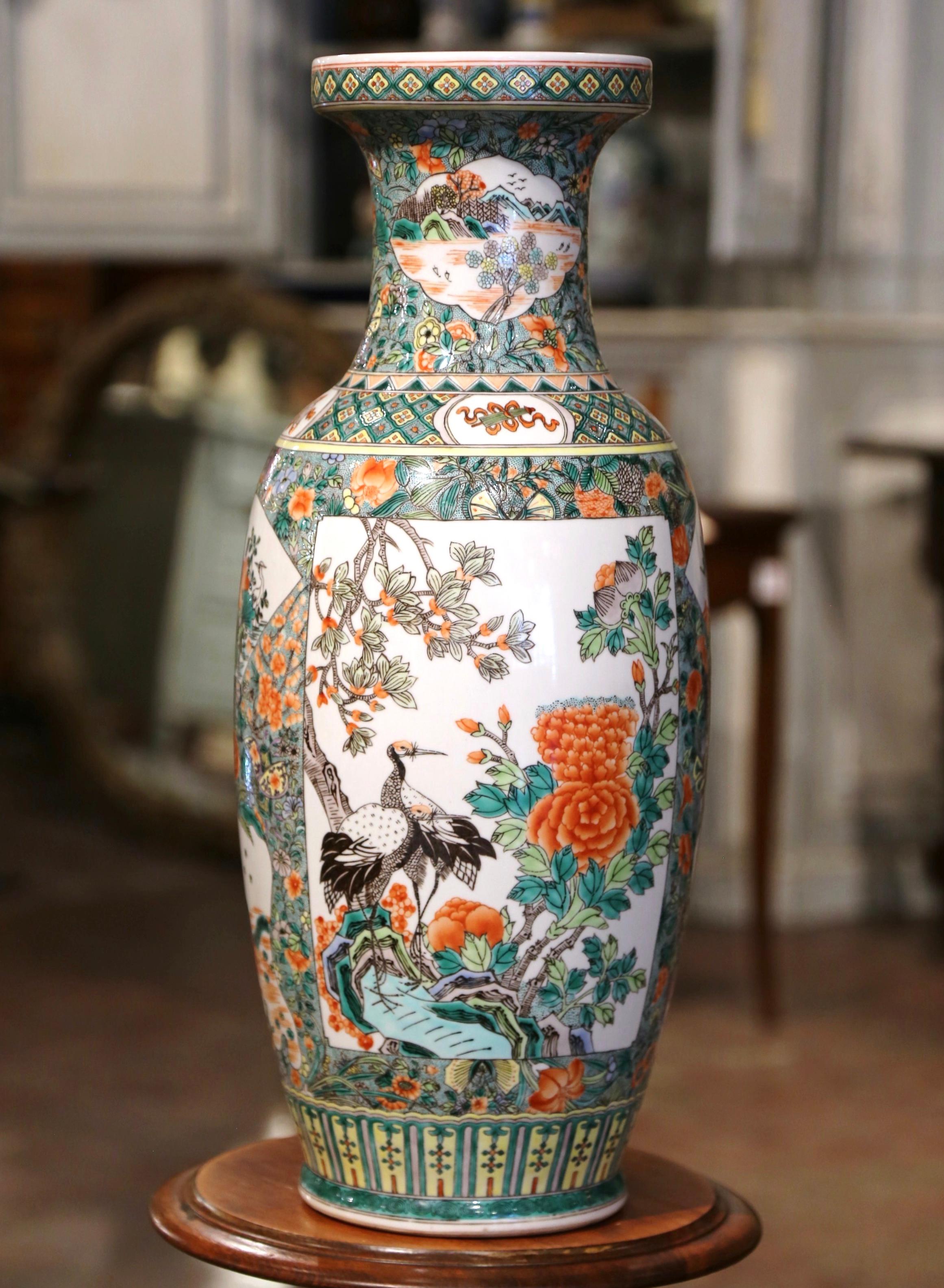 Decorate a table or a console with this colorful antique porcelain vase. Crafted in China circa 1950, the important Family Verte vessel is round in shape decorated with a wide neck at the top. The tall vase is embellished with hand painted avian and