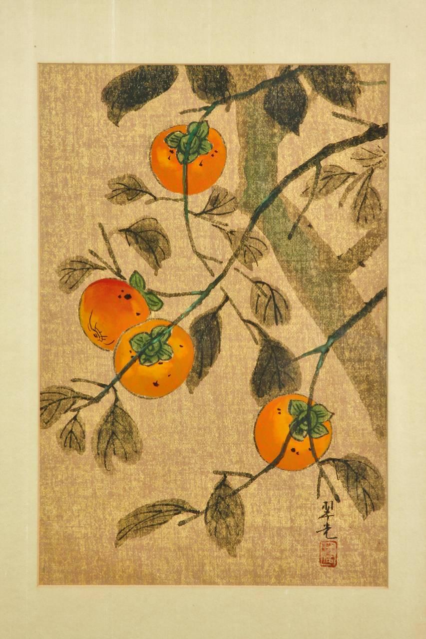 Colorful midcentury Chinese ink and color painting depicting a fruiting persimmon tree. Features a beautifully textured gilt ground with brightly colored fruit and dark foliage. Signed and sealed on bottom right. Professionally mounted in a rich