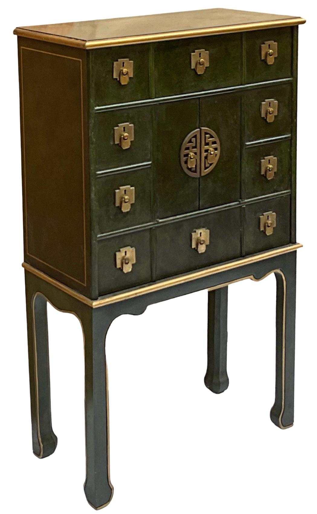 This is a pair of Ming style green and gilt storage cabinets. They are styled to mimic a chest or box on stand. The pair are in very good condition. The cabinets would make great storage for office to lingerie to jewelry. They are unmarked. 
