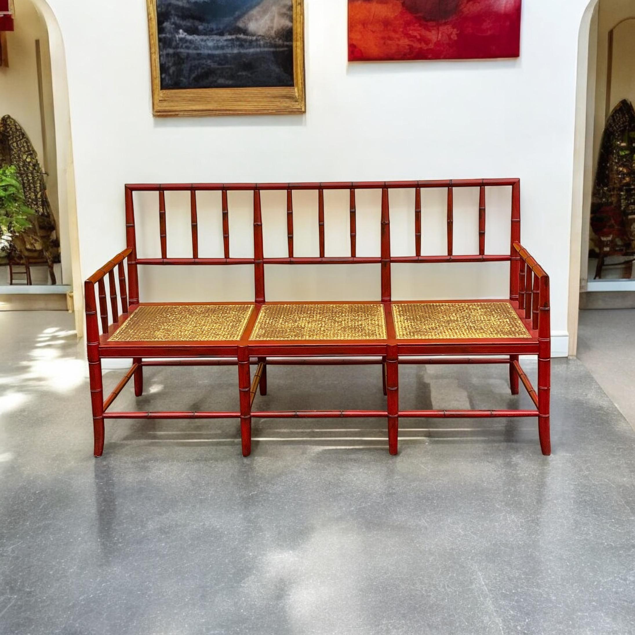 This is a really good looking large scale English Chinese red carved faux bamboo settee with a cane seat. The seat is 17.5”H. The arm is 27.5”. The painted frame is intentionally distressed. 

Shipping can run two to five weeks. Ferries are