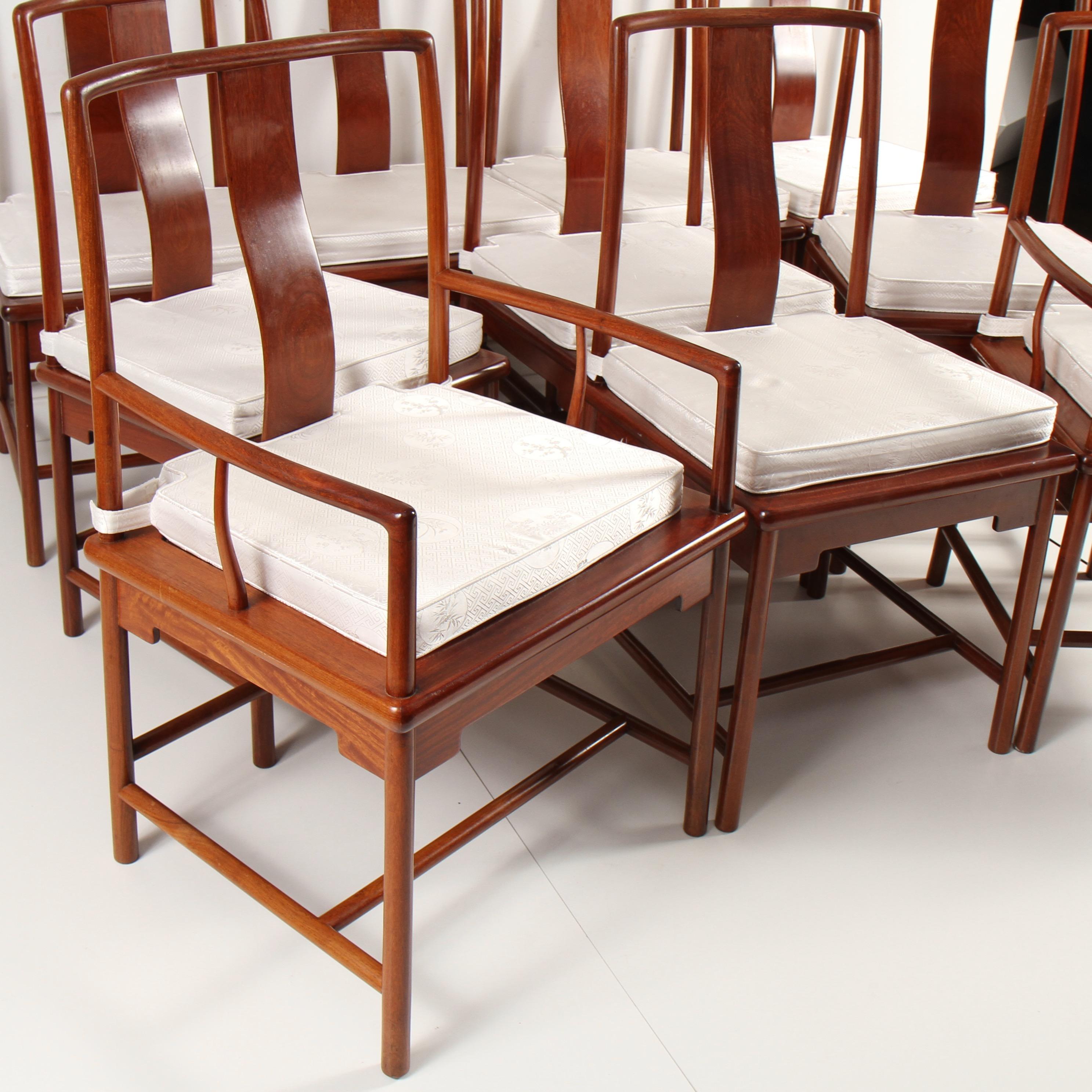 Fabulous Chinese rosewood dining chairs. An exceptional set of 10 chairs, 8 side chairs and 2 armchairs. All created out of solid rosewood in the Ming style. Set is in very good condition with minimal wear. Custom made seat cushions are in great