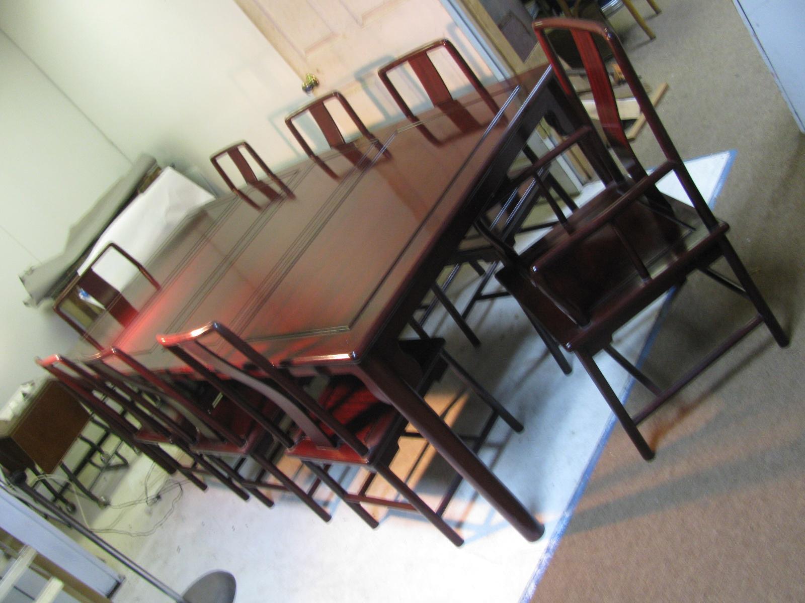Fabulous Chinese rosewood dining room table with 8 chairs. An exceptional set which includes a table with 2 leaves, and eight chairs, (6 side chairs and 2 arm chairs. All created out of solid rosewood in the Ming style. Set is in very good condition