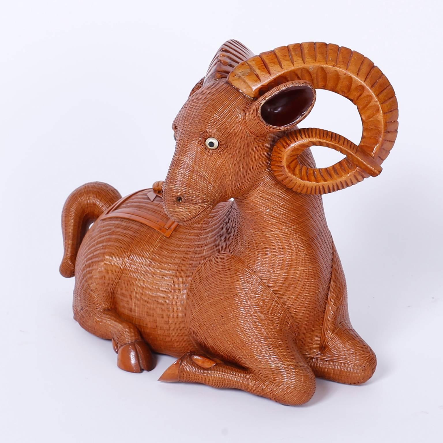Wicker ram ambitiously crafted with tightly woven reed, carved wood horns and a removable lid that opens for storage. From the Shanghai collection.