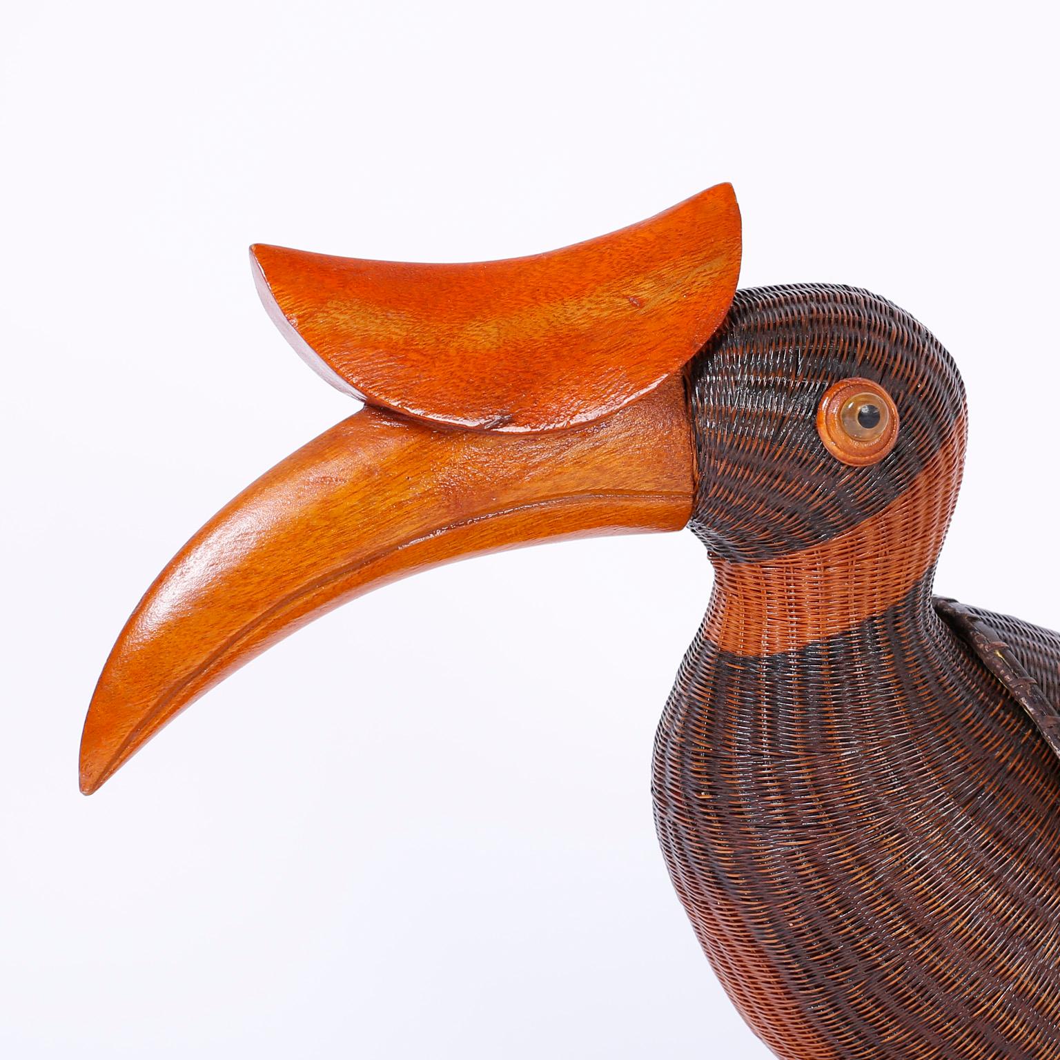 Whimsical wicker Chinese lidded toucan from the famed Shanghai collection with its distinctive intricate weave embellished with a carved wood beak and tail feathers. All perched on a bamboo base.