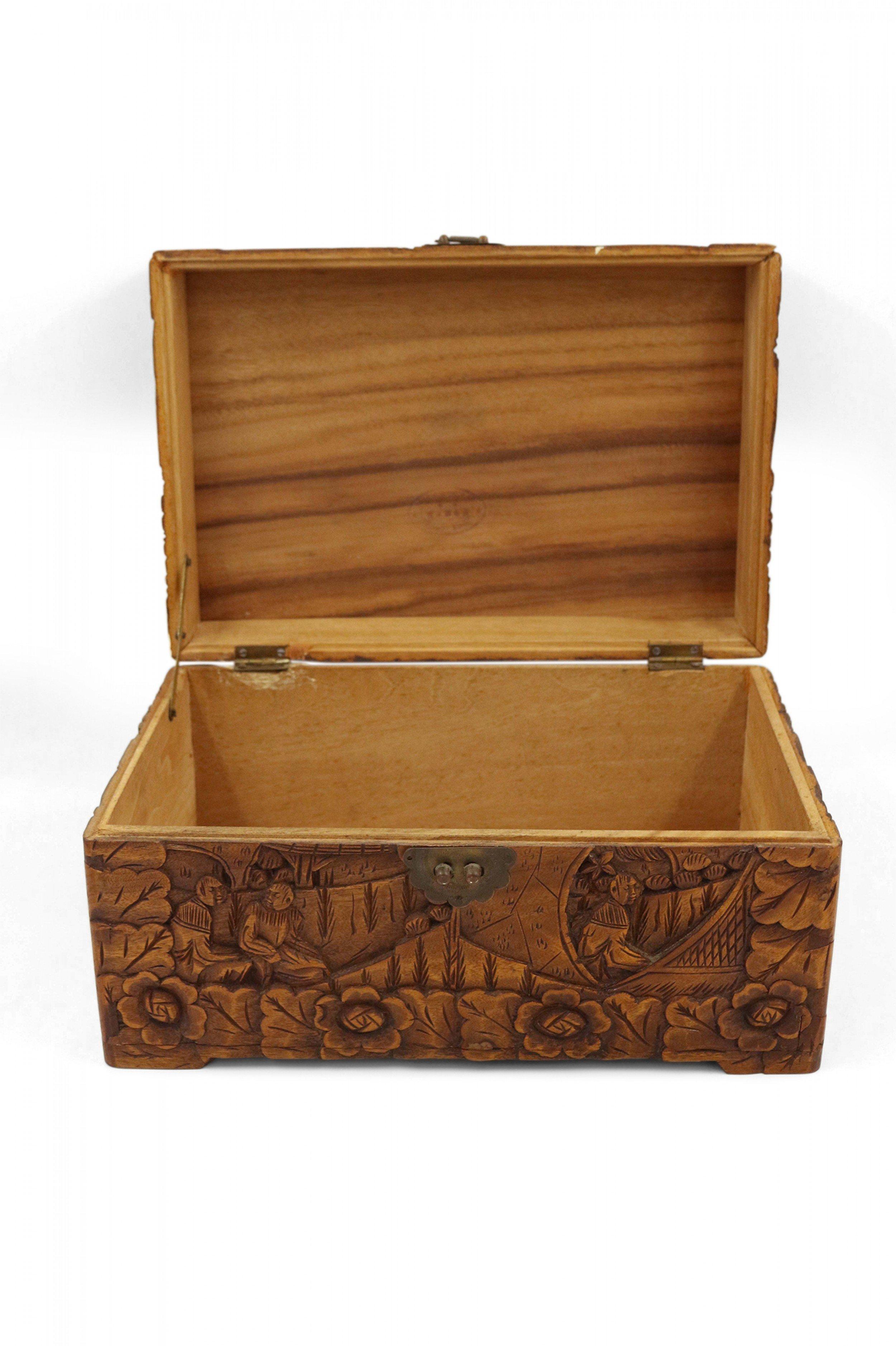 Mid-century Chinese carved wooden box featuring an elaborate scenic design with a hinged top and brass closure hardware. (Stamped HUNG HOP CHEST CO. HONG KONG).
     