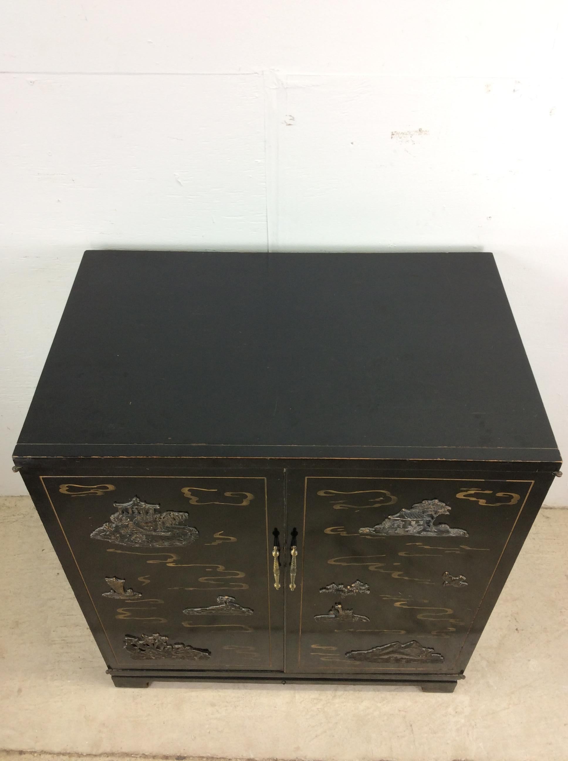 This mid century chinoiserie chest of drawers features hardwood construction, black paint finish, two cabinet doors with Chinese imagery in gold paint and brass, eight dovetail drawers, and brass hardware.

Dimensions: 31w 21d 35h

Condition notes: