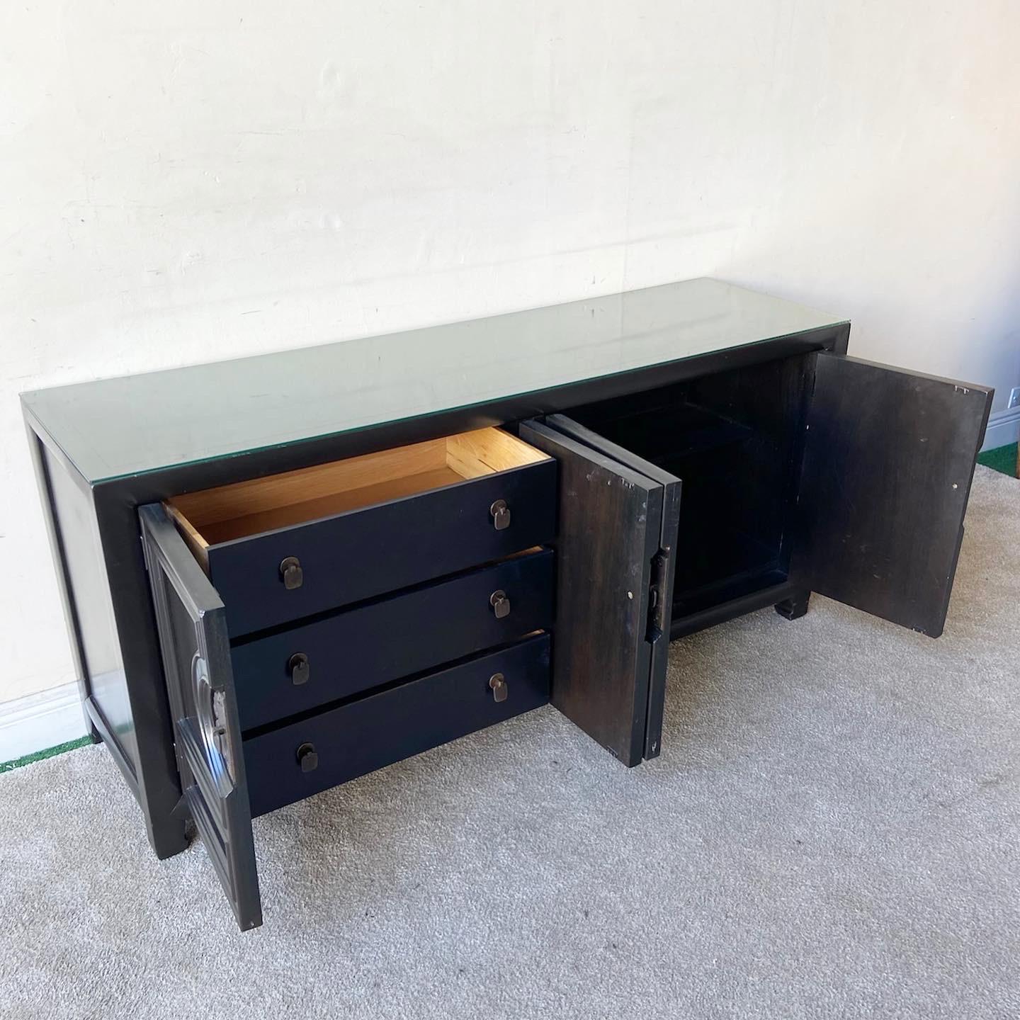 Exceptional mid century chinoiserie credenza by Century Furniture Co. Features a glass top with brass handles.

Additional information:
Material: Wood
Color: Black
Style: Mid-Century Modern
Brand: Century Furniture
Time Period: 1970s
Place of