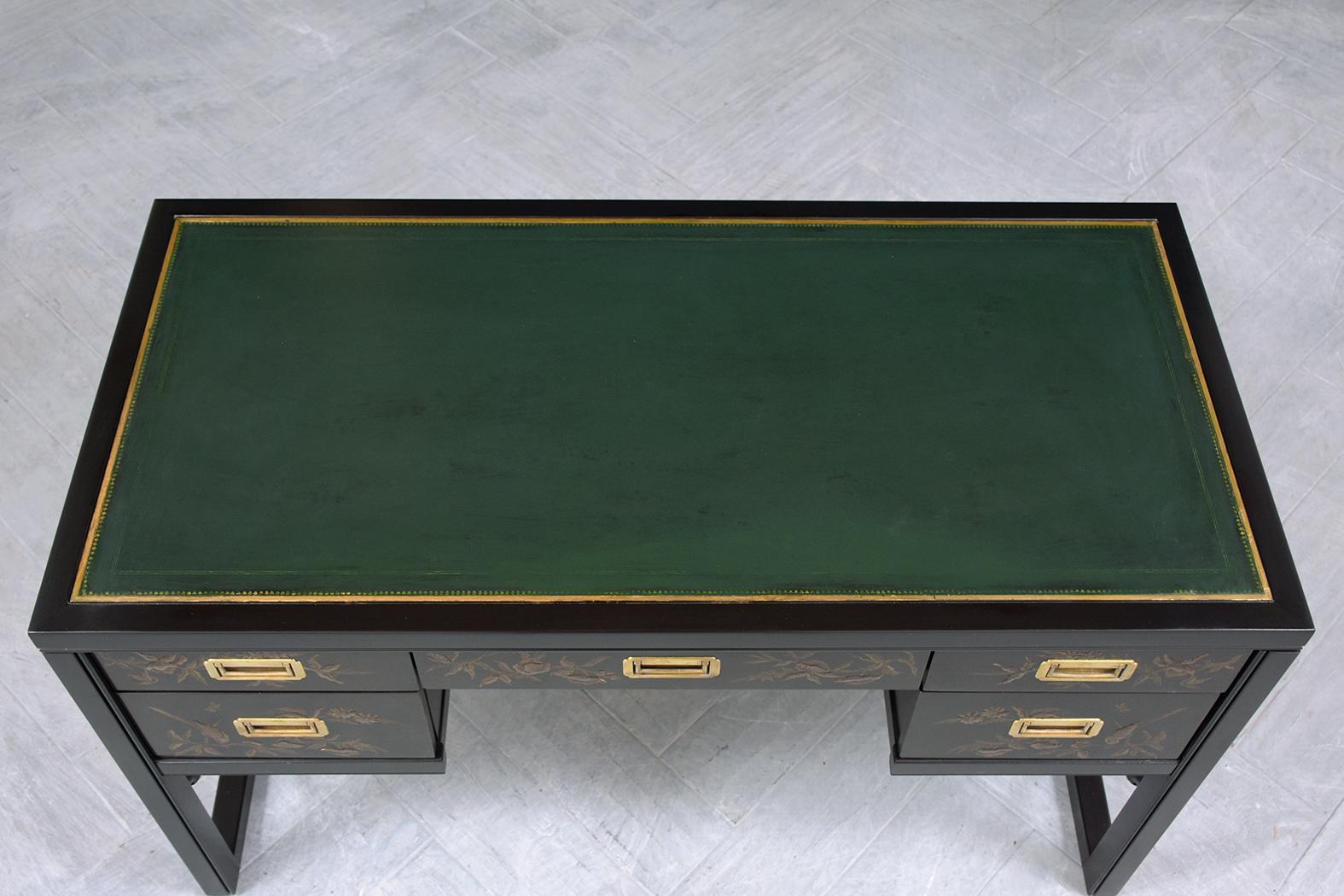 This extraordinary 1970s campaign desk is in good condition beautifully crafted out of mahogany wood and completely restored by our professional expert craftsmen team. This writing table features a dark green leather top accentuated by embossed gilt