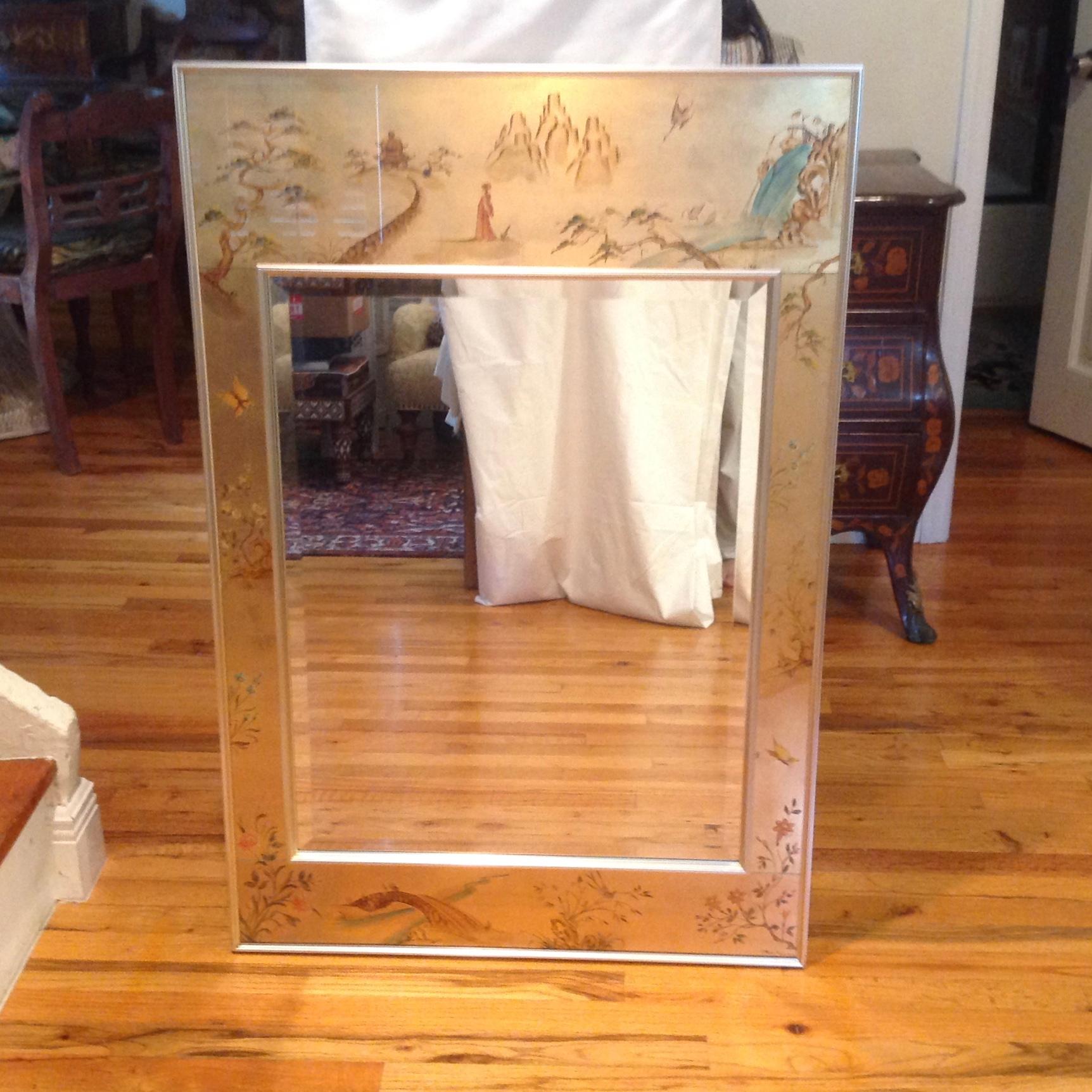 An elegant and refined reverse painted mirror - signed La barge. 
It is decorated with gilded and hand painted chinoiserie themes.
The mirror is bevelled and the frame work is accented with chrome.
Artist signed, 1978. Simply stunning.