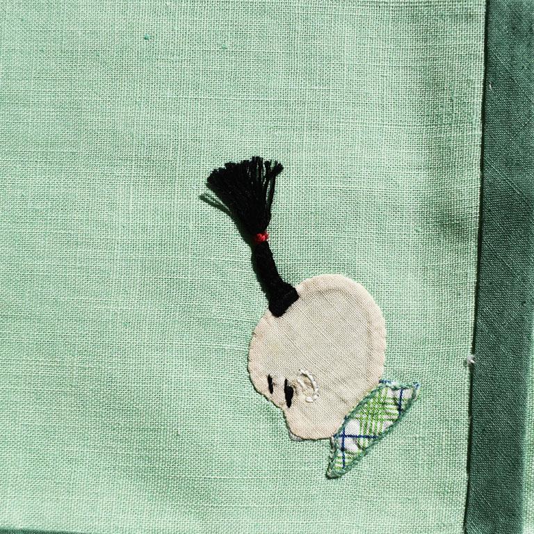 A set of four mint green linen table or cocktail napkins. The perfect addition to your current barware, this set of cocktail napkins will bring a touch of chinoiserie to any setting. Each napkin is created from mint green linen, with a darker green