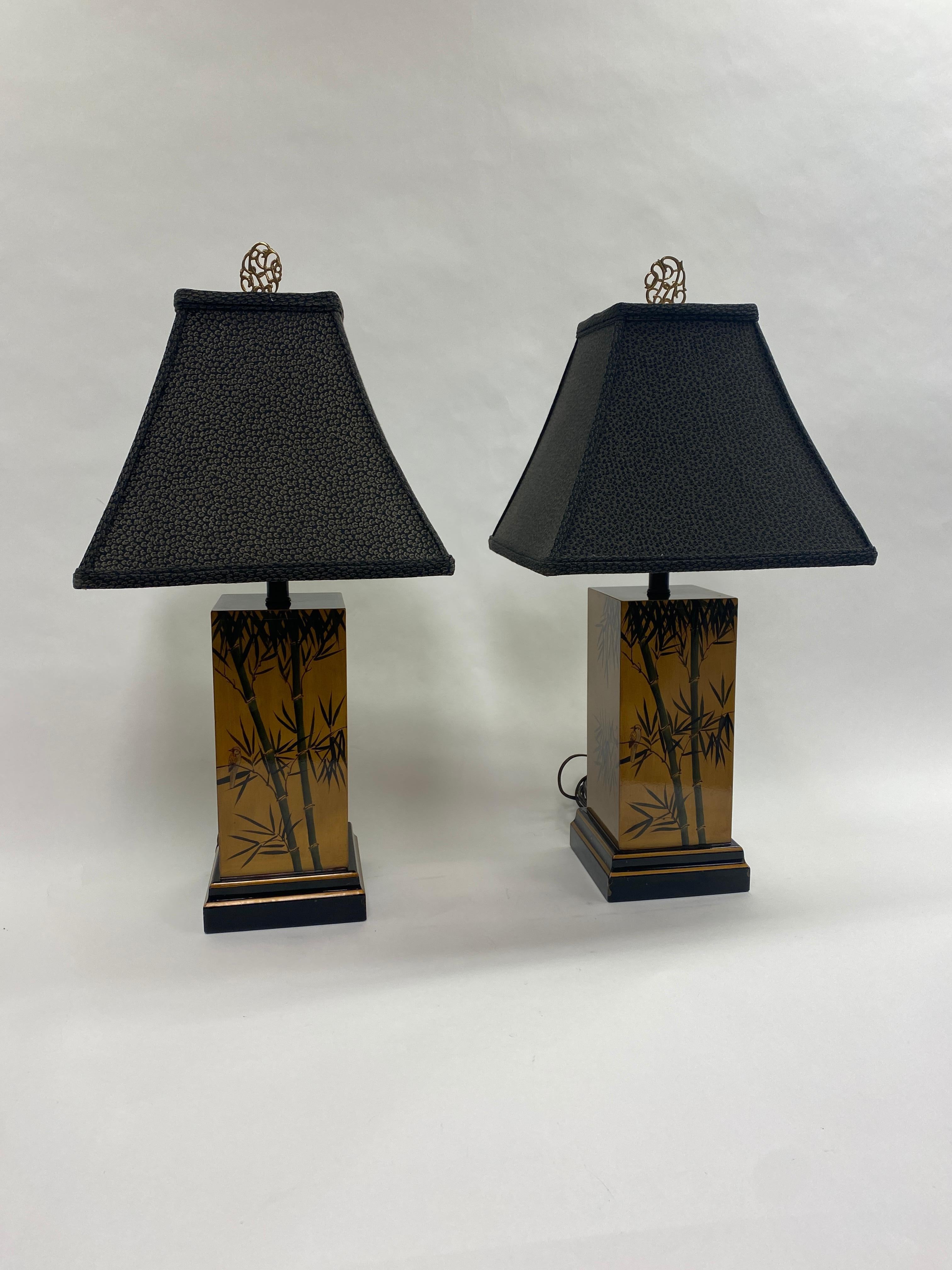 A nice mid-century pair of square Chinoiserie table lamps decorated with hand painted bamboo and lacquer over gilt wood. Black shades with brass finials. 

Lamp body is 6.25