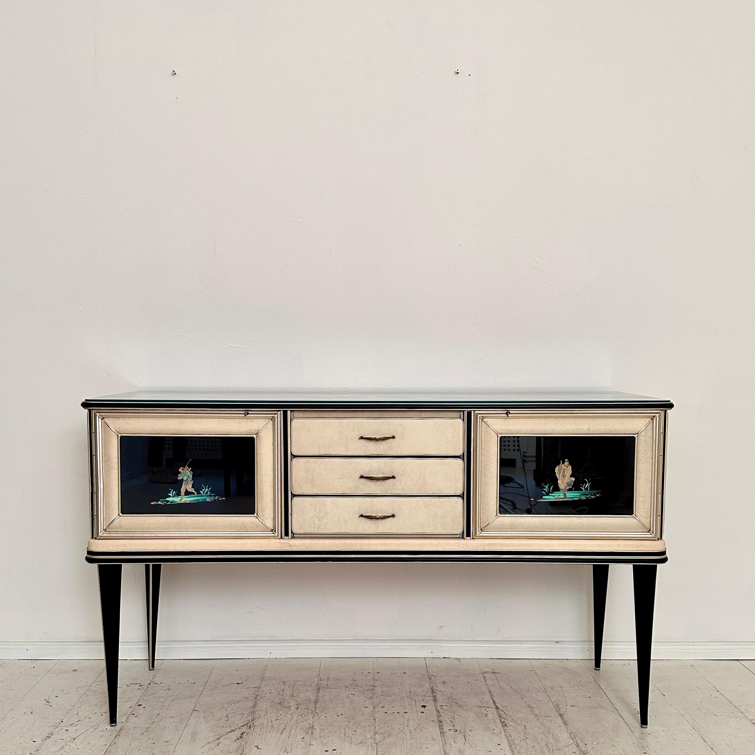This fantastic Mid-Century Chinoserie Sideboard by Umberto Mascagni was build as a limited Edition for Harrods London around 1953.
It has got a door with shelf on each side and 3 drawers in the middle.
A unique piece which is a great eye-catcher for
