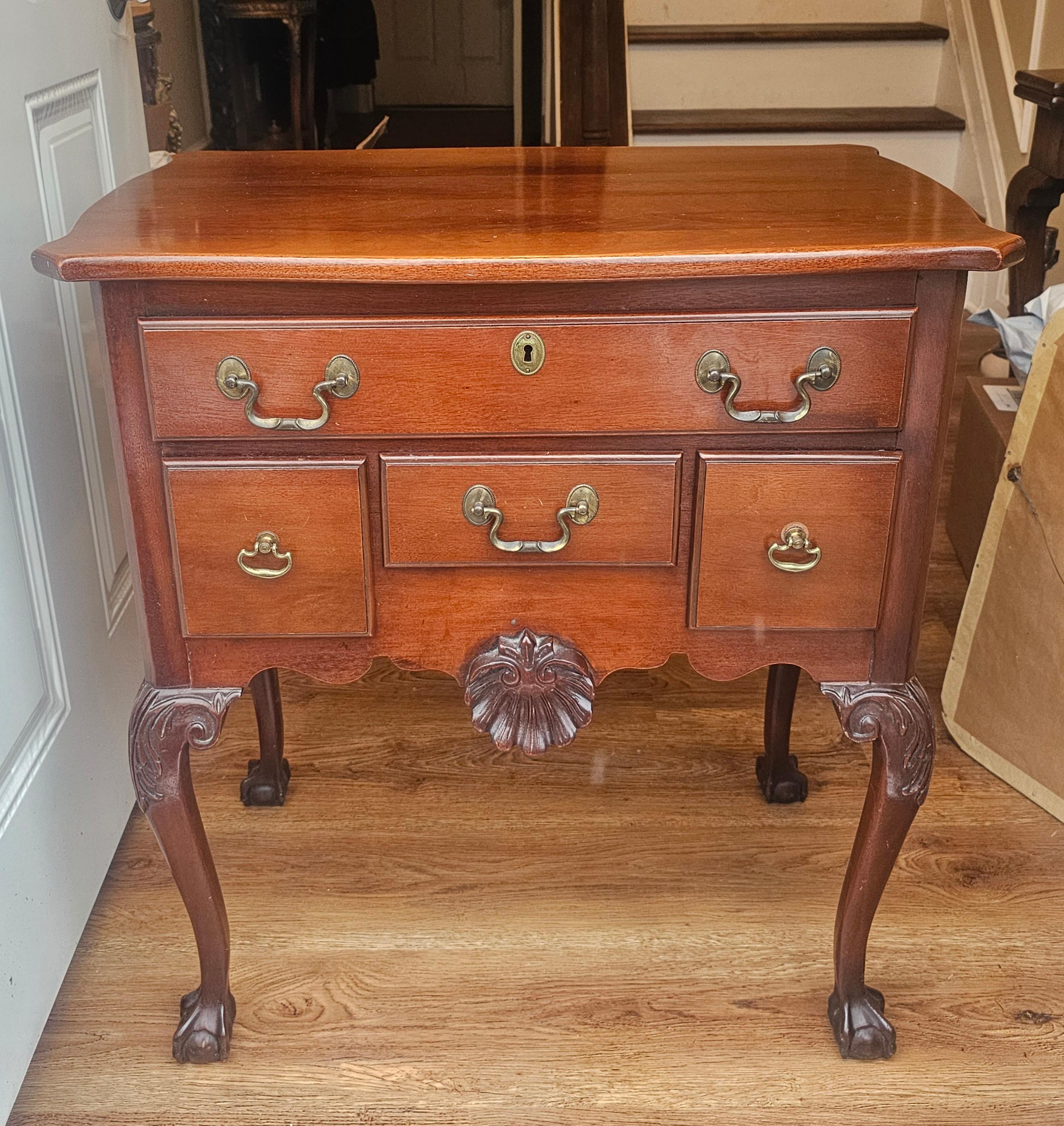  A Mahogany Chippendale Style Lowboy Table or Nightstand. 
Style: Chippendale style with Queen Anne influences, dating back to the 1940s. 
Material: Constructed from mahogany, known for its durability and rich color. 
Design: Features four drawers,
