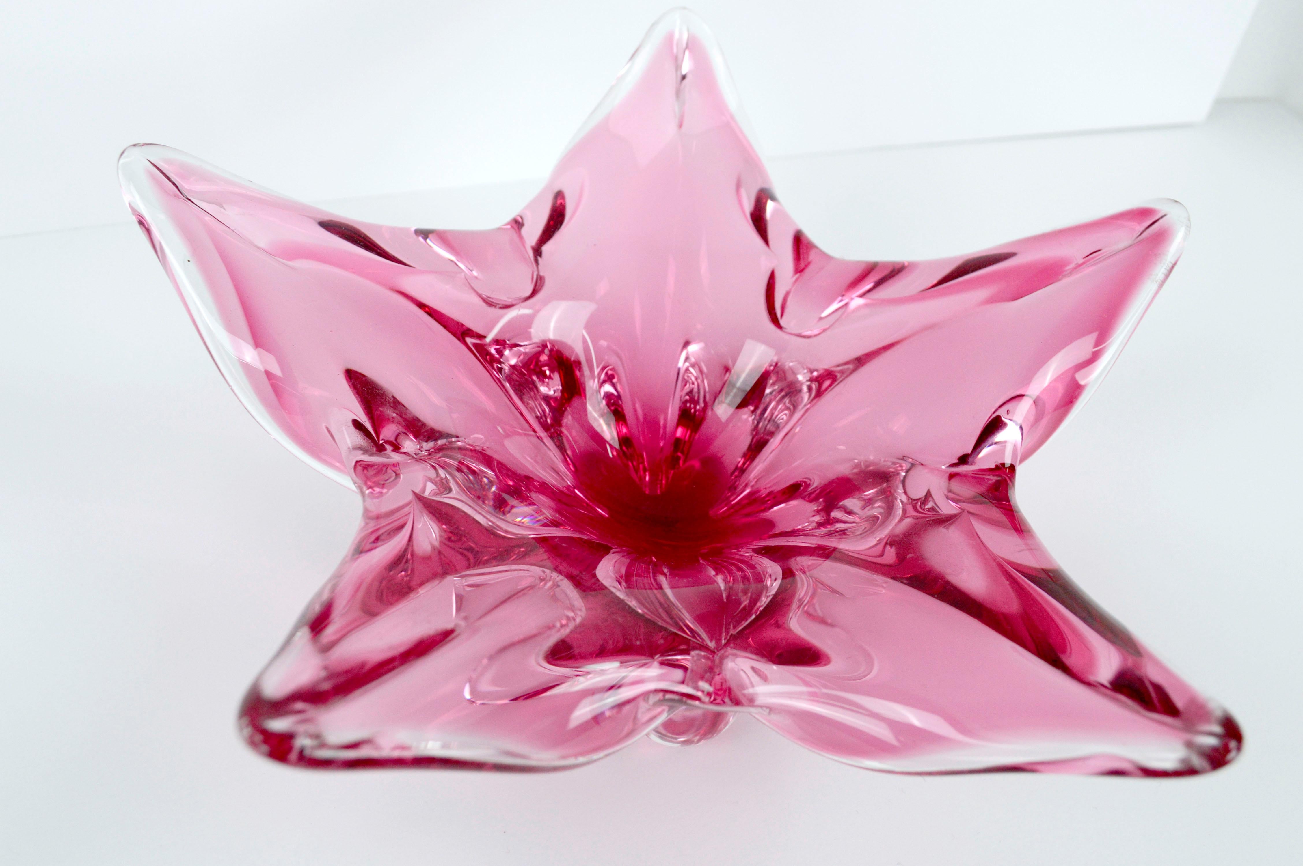 Mid Century Modern Chribska Glassworks, Czech Pink Star Flower Footed Glass Dish

Stunning petaled flower or 5 pointed star-shaped footed hand made glass dish in clear and pink/cranberry by Josef Hospodka (Czechoslavkian, 1923-1989) of SKLO Union