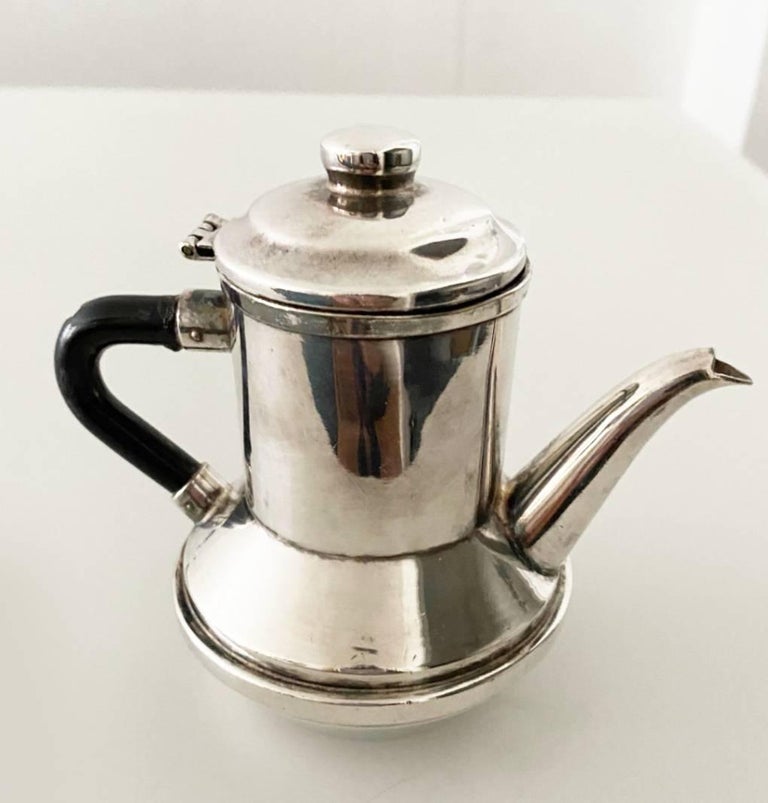 Beautiful Silver Tea/Coffee pot by Christian Dior, ebony color Bakelite handle. Art Deco design incorporating structure and decoration in a harmonious balance and hand-crafted design,  markings on bottom of pots - Christian Dior - Modele Depose -