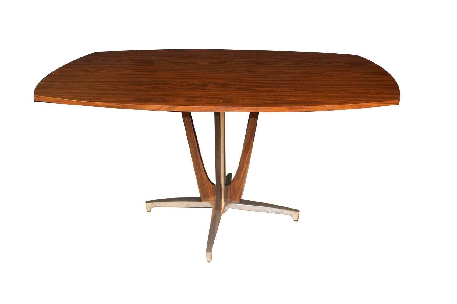 Vintage Mid-Century Modern ’69 Chromcraft oval dining table. This beautiful, retro, Chromcraft table features a walnut laminate with a flared veneer and polished chrome pedestal base and a chrome star 4-legged base. The table is very durable and