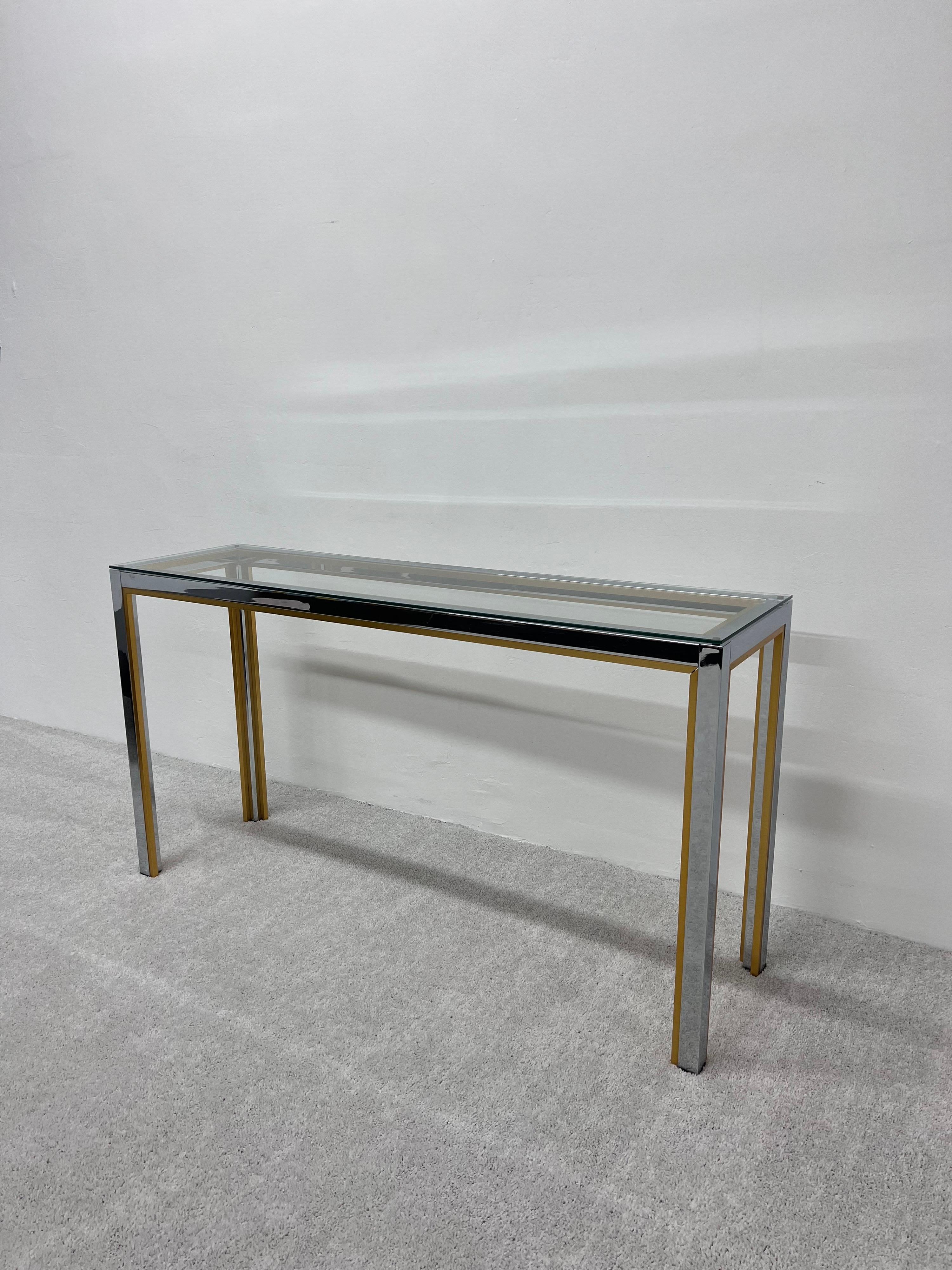 Chrome and yellow plated metal console table with glass top in the style of Romeo Rega. Italy, 1970s.