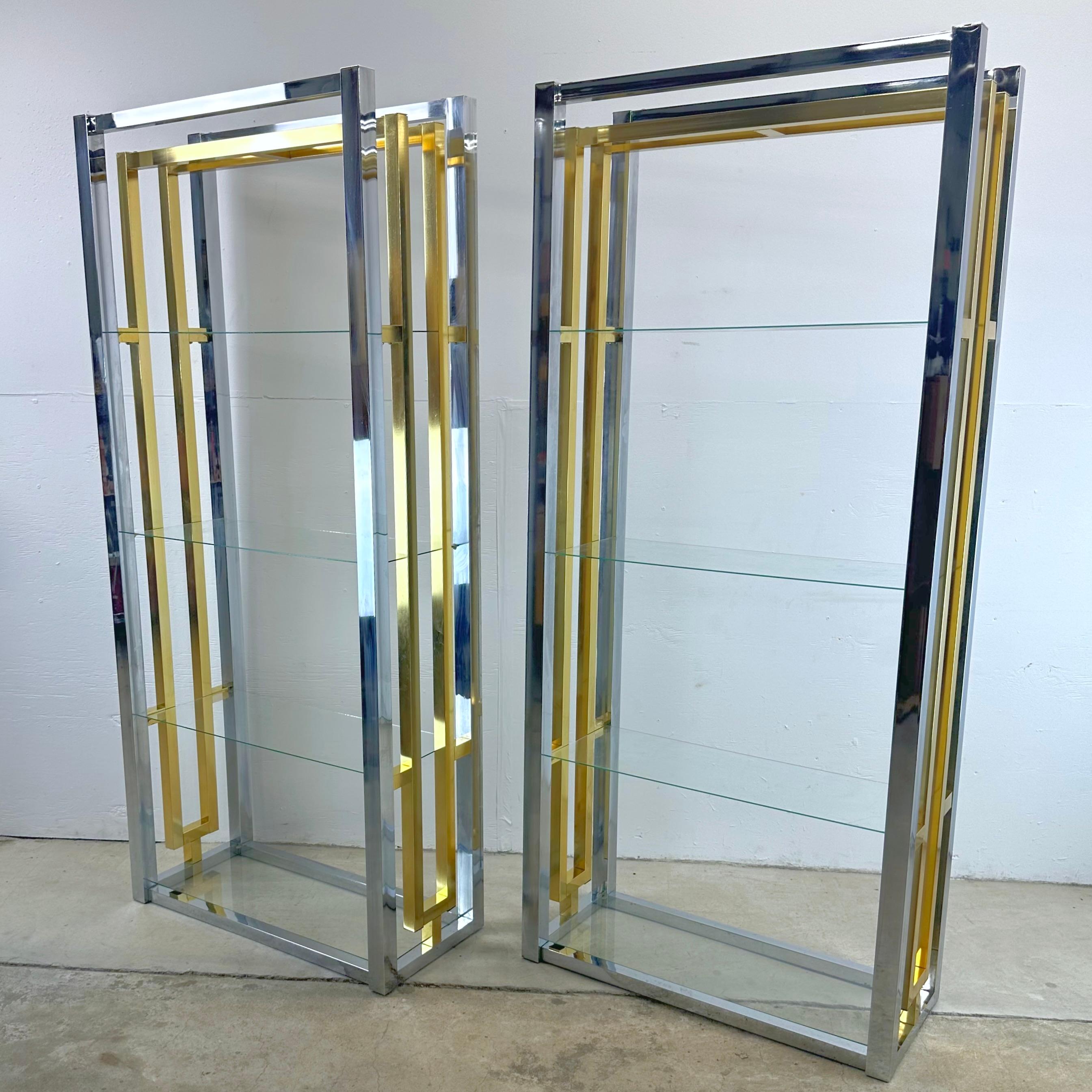 Embrace the timeless charm of mid-century design with this stunning pair of chrome and brass finish etageres with glass shelves. These pieces pay homage to an era where sleek lines, the fusion of metal and glass were synonymous with style, and they