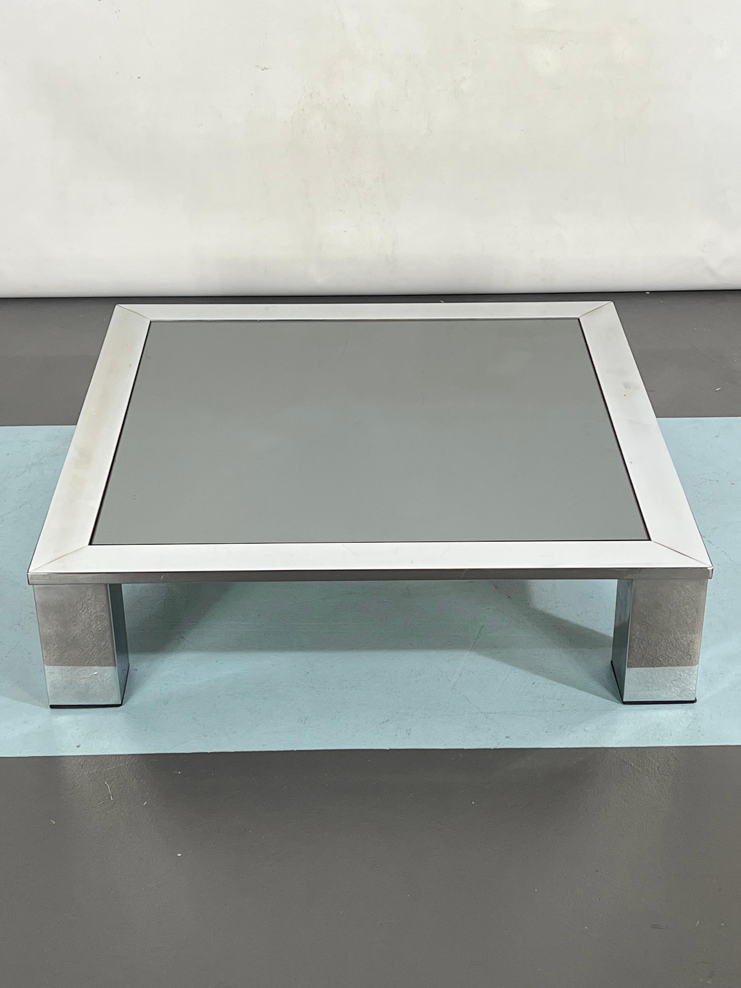 Great vintage condition with normal trace of age and use for this side table produced in Italy during the 70s and made from chrome and dark mirror glass.
