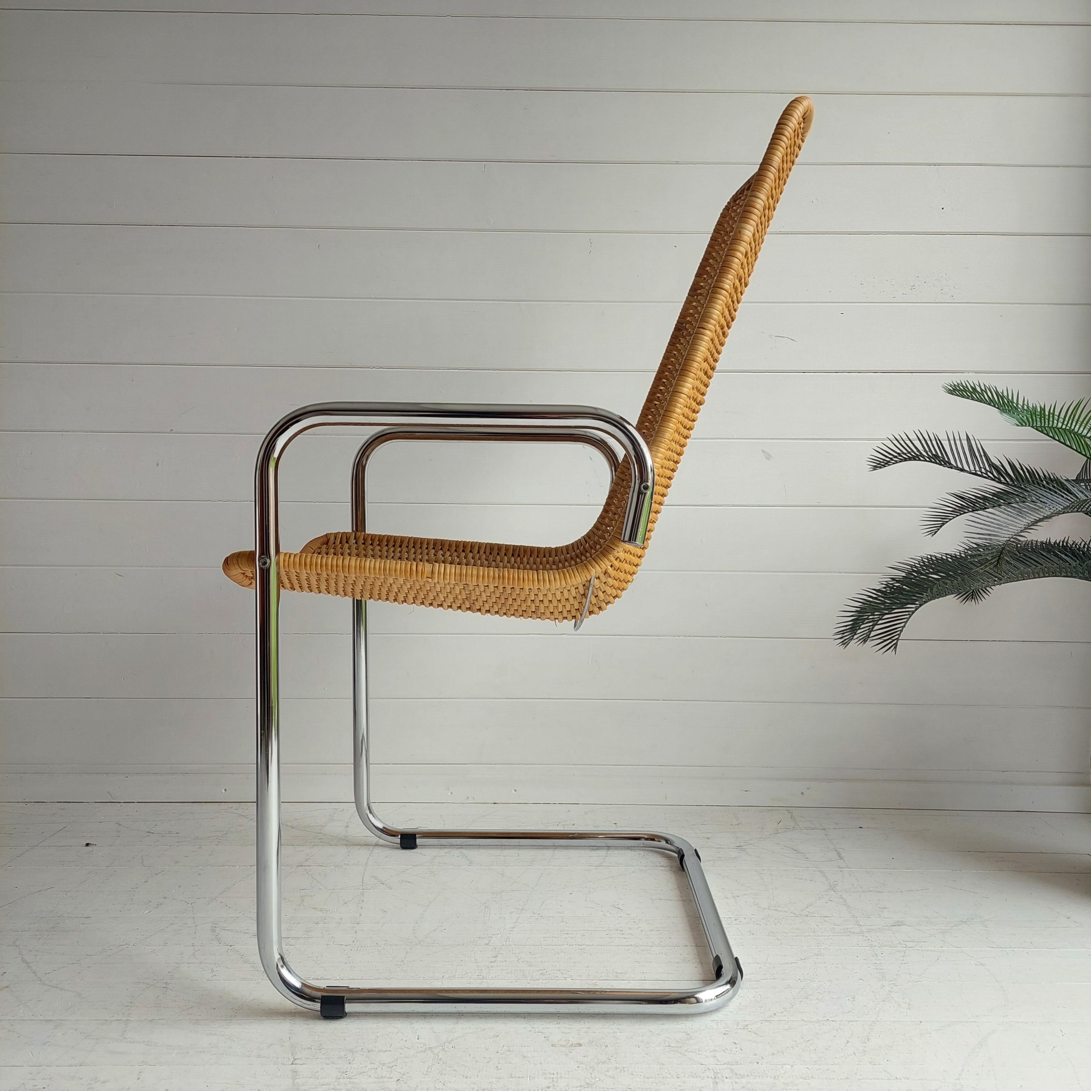 Here is a great, rare example of Mid-Century Modern design from the 1970's - Bauhaus style Breuer / Mies Van Der Rohe 
A side chair in the style of Cidue, Italy. 
A cantilever chrome frame holds a rattan shell highback seat. 
Classic piece. Bare
