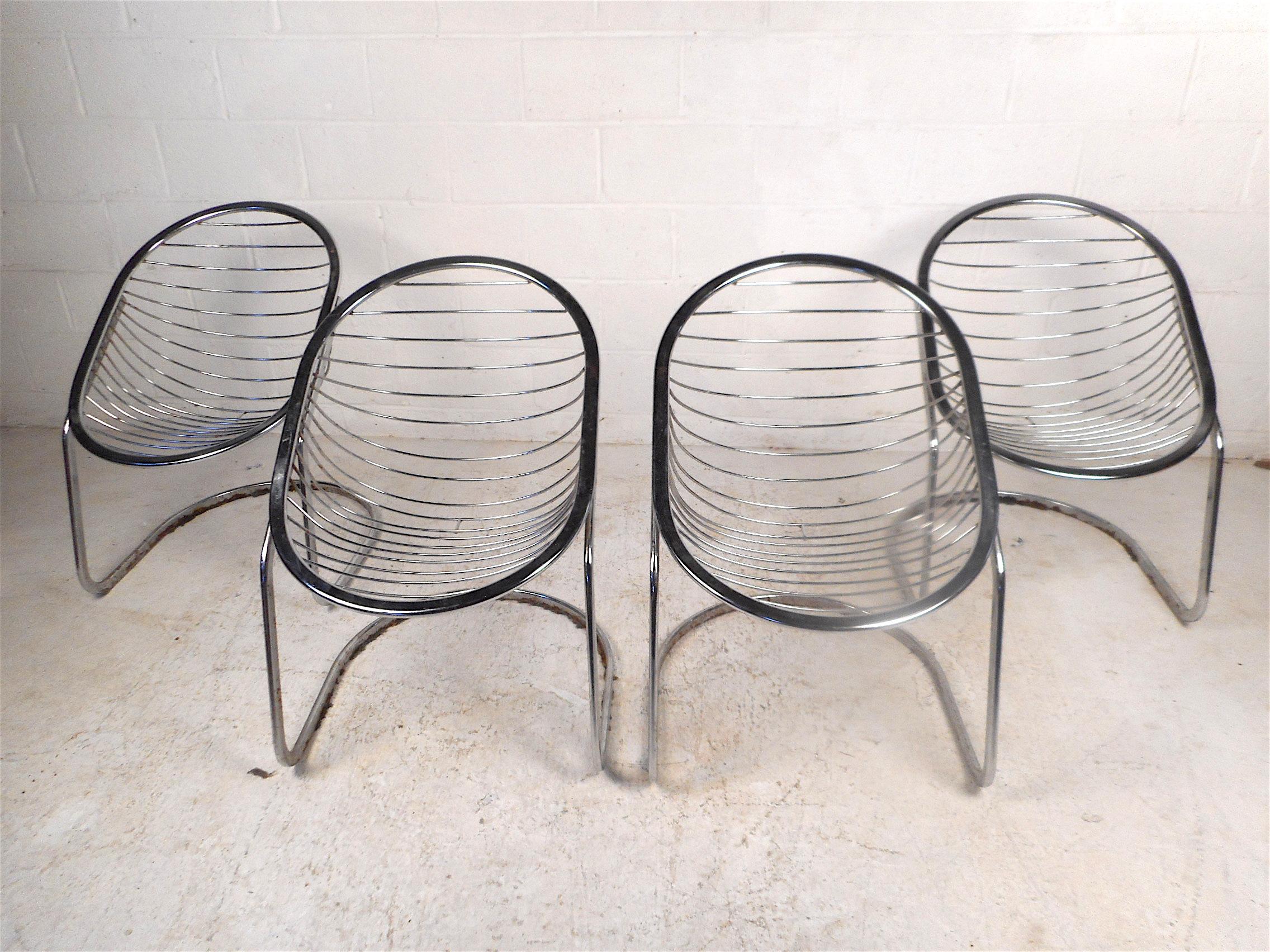 Stylish and unusual set of 4 cantilevered mid-century chairs. Chrome frame. Offset oval-shaped seats combined with sleek bases give these chairs a unique and striking visual profile. Sure to impress in any modern decor. Please confirm item location