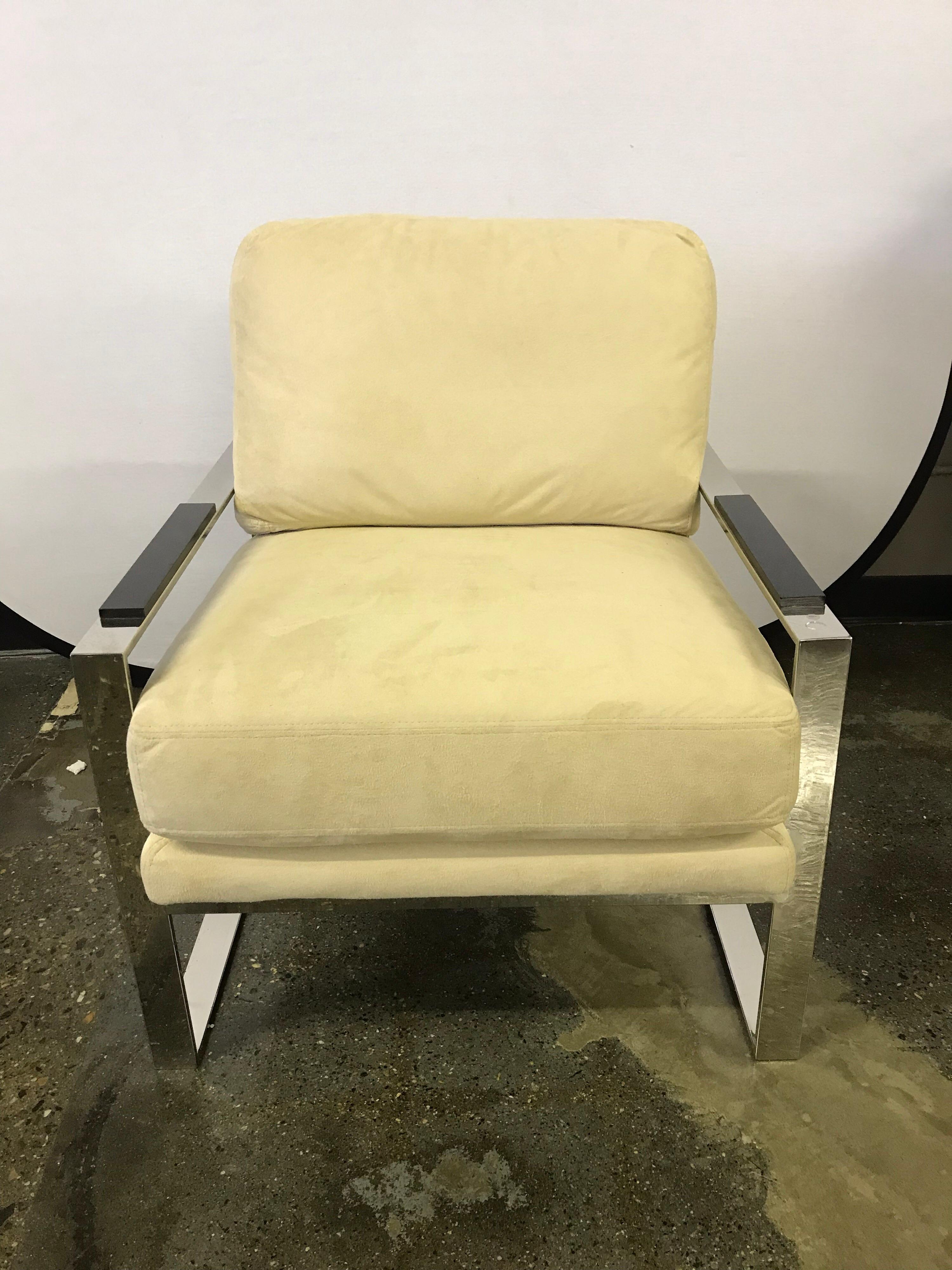 Mid century style chrome cantilevered chair has a deep comfortable seat, a sturdy frame and a wonderful modern aesthetic. Upholstery is pale yellow. 