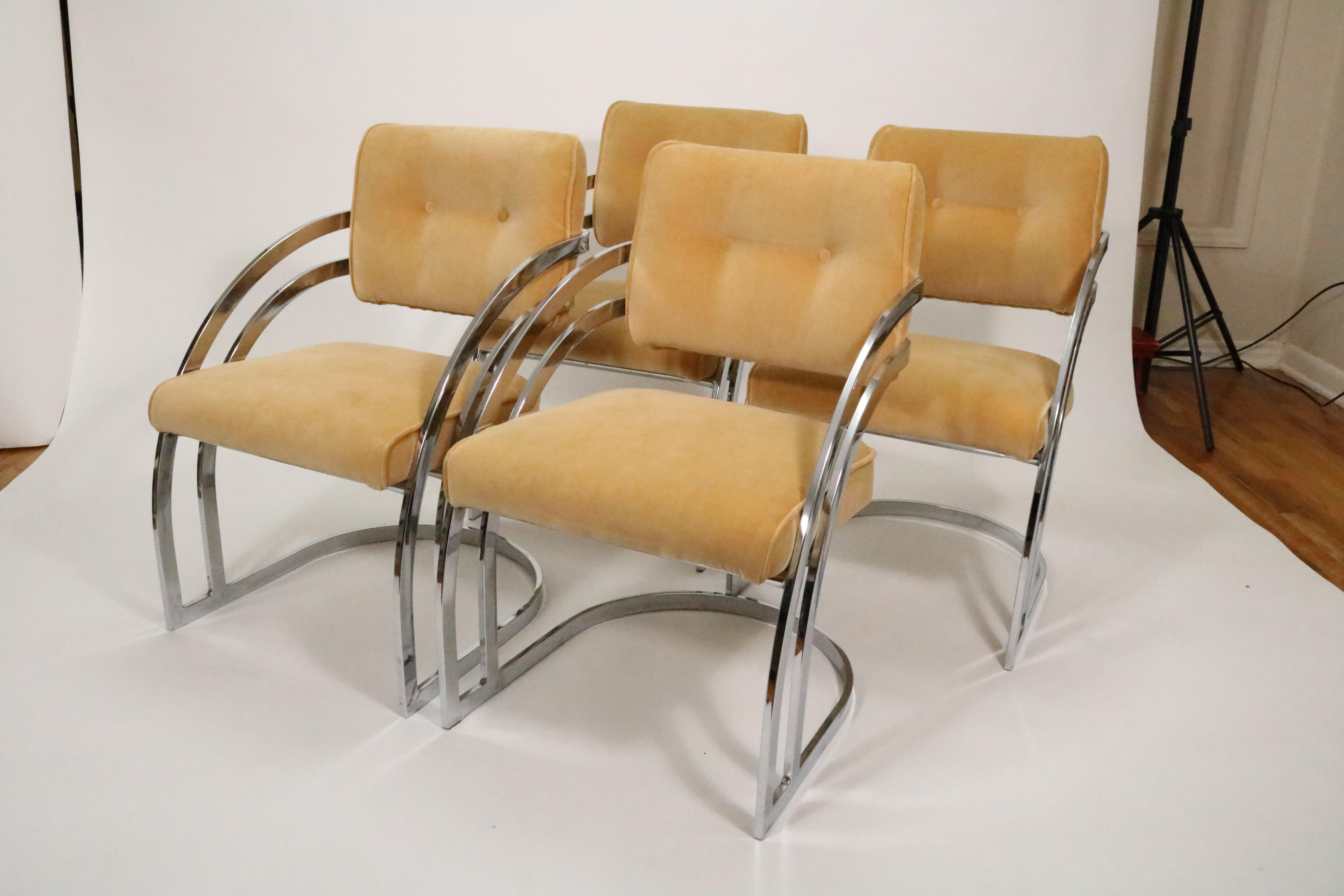 A set of four sculptural chromed steel dining chairs by Cal-Style. The chair back's double bar design and waterfall cantilevered frame create a unique focal point. 

The ample cushions provide comfortable support on the seatbacks and