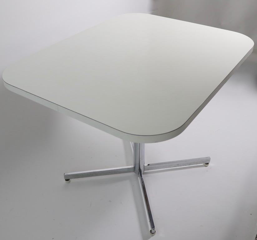High quality chrome and Formica cafe, kitchen, dining table. Rectangular top, with chrome pedestal base on four star leg base. The table is very solid, well built, clean and ready to use. Originally designed as a kitchen table, suitable for use as a