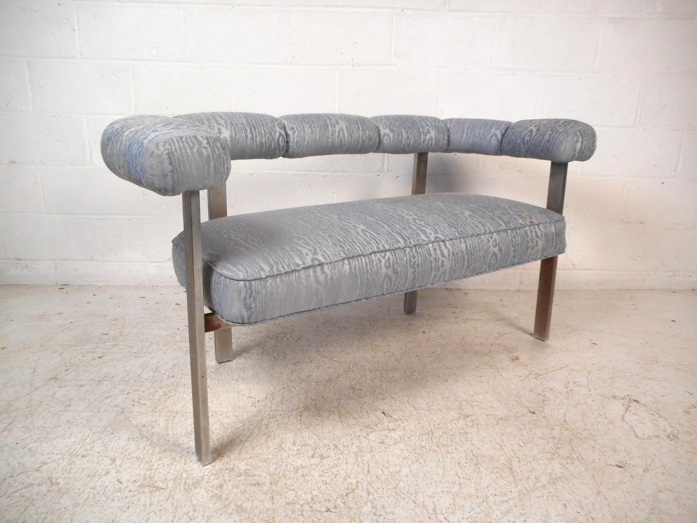 Unusual midcentury upholstered bench with a sturdy chrome frame. Comfortable and spacious seating area, with padded arm/backrests covered in a textured light blue vintage upholstery. An interesting addition to any modern interior. Please confirm
