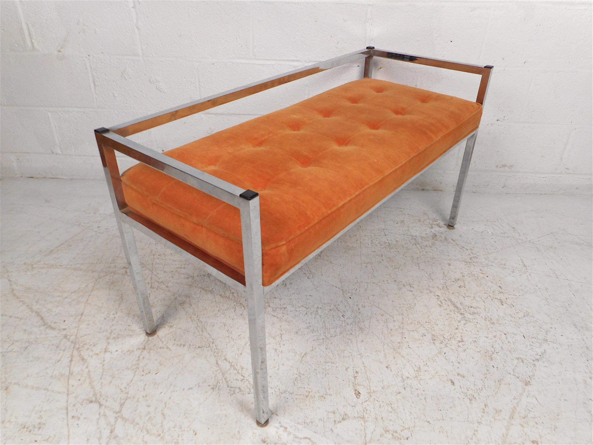 Stylish midcentury settee with a chrome frame. Seat is covered in a vintage tufted orange upholstery. Simplistic yet eye-catching design. Sure to make a great addition to any modern interior. Please confirm item location with dealer (NJ or NY).
