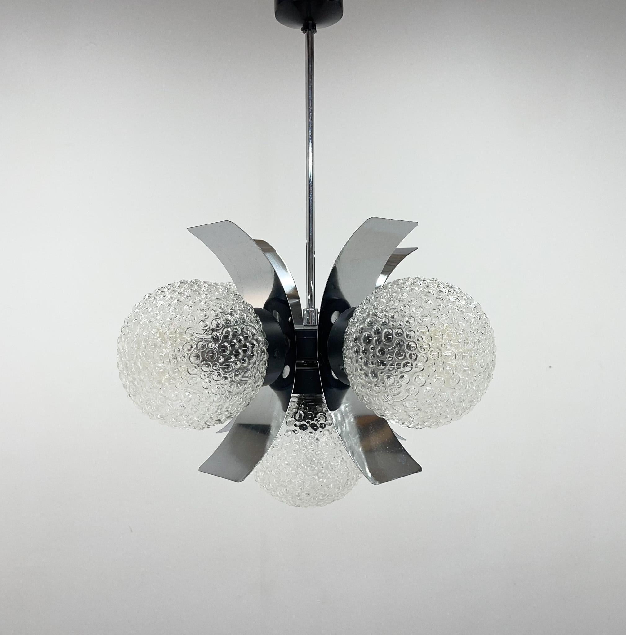 Vintage chandelier made of chrome and pressed glass in former Czechoslovakia in the 1970's. Manufactured by Elektroinstala Decín. Bulb: 5 x E25-E27.