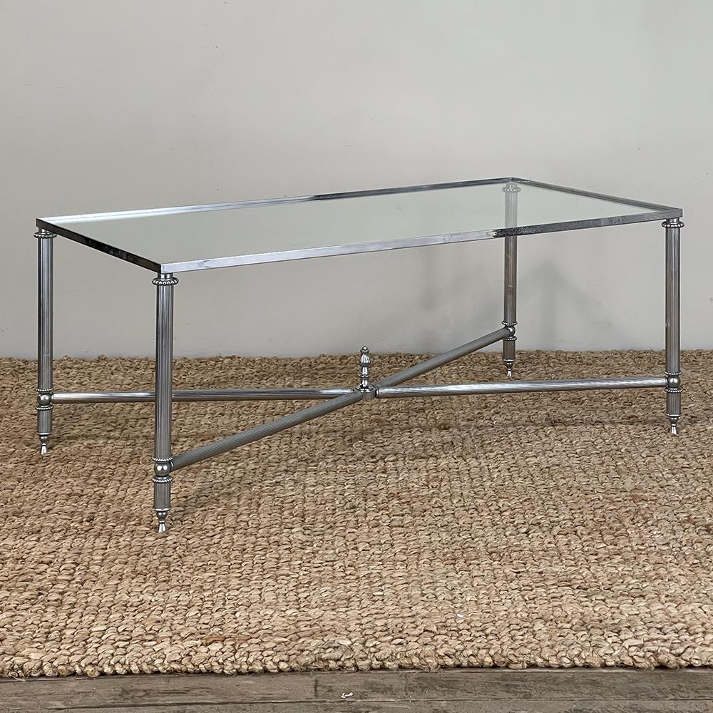 Mid-Century Chrome & Glass Coffee Table combines subtle classical elements in a modern, contemporary look that is truly timeless!  The full-coverage glass top ensures you never have to worry about rings or spills, while the chromed framework adds a