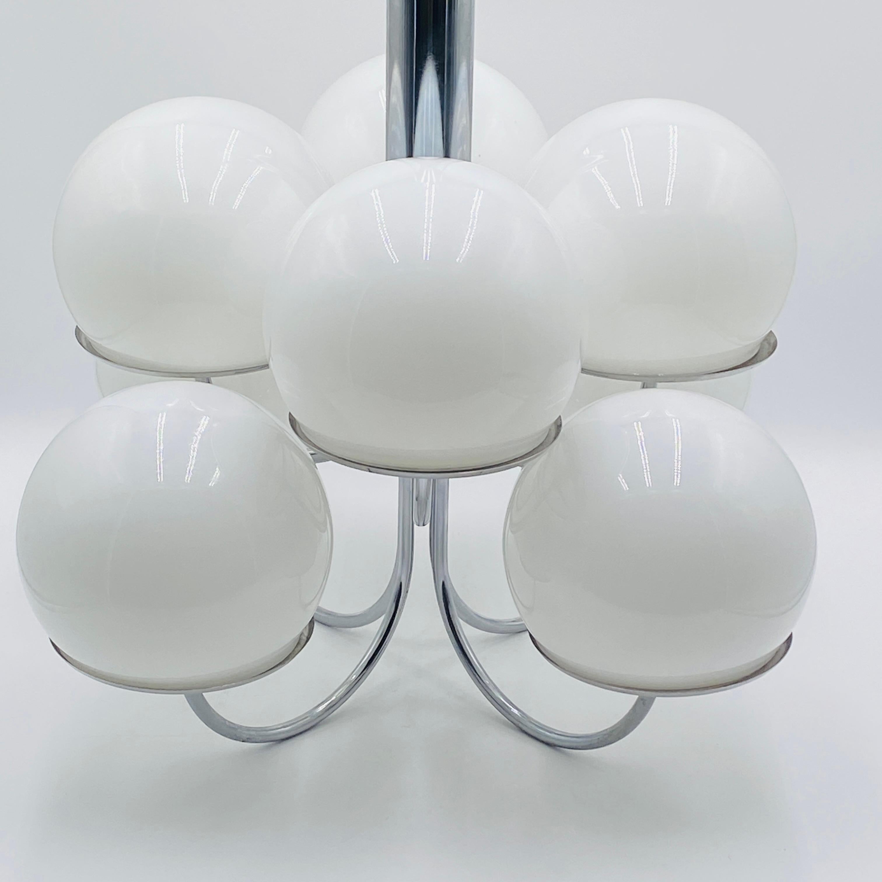 A rare chrome and glass globe chandelier by Lightolier. 8 glass globes nest onto the chrome chandelier, casting a very warm and gentle light. 

Founded in New York City in 1904, Lightolier has been at the forefront of lighting innovation for more