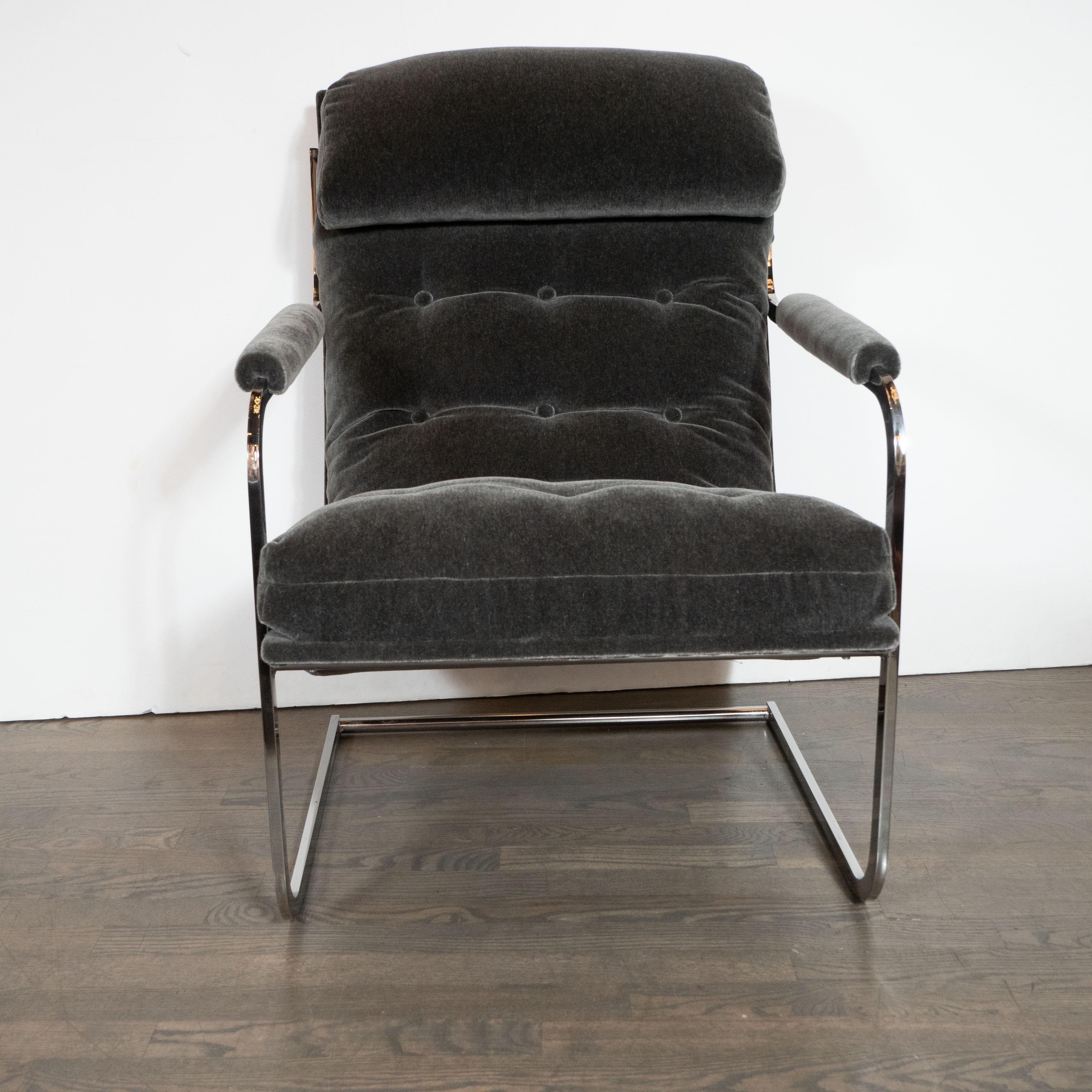 This dramatic and refined pair of Mid-Century Modern chairs were realized by the manufacturer Carsons of High Point in the United States, circa 1970. The feature tubular frames appear forged from a single piece of snaking lustrous chrome, that
