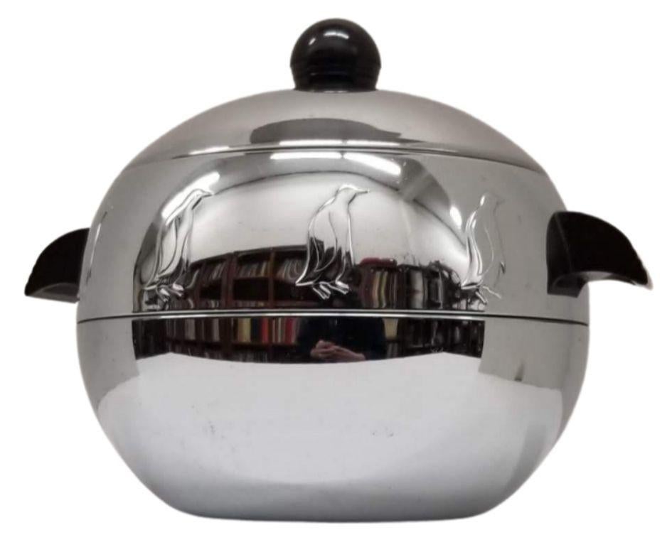 Mid Century-era chromed steel ice bucket with phonic resin handles featuring raised penguin relief by The West Bend Company. Penguin Hot & Cold Server

The Mid-Century chrome ice bucket was a sleek and futuristic home decor item popular in the