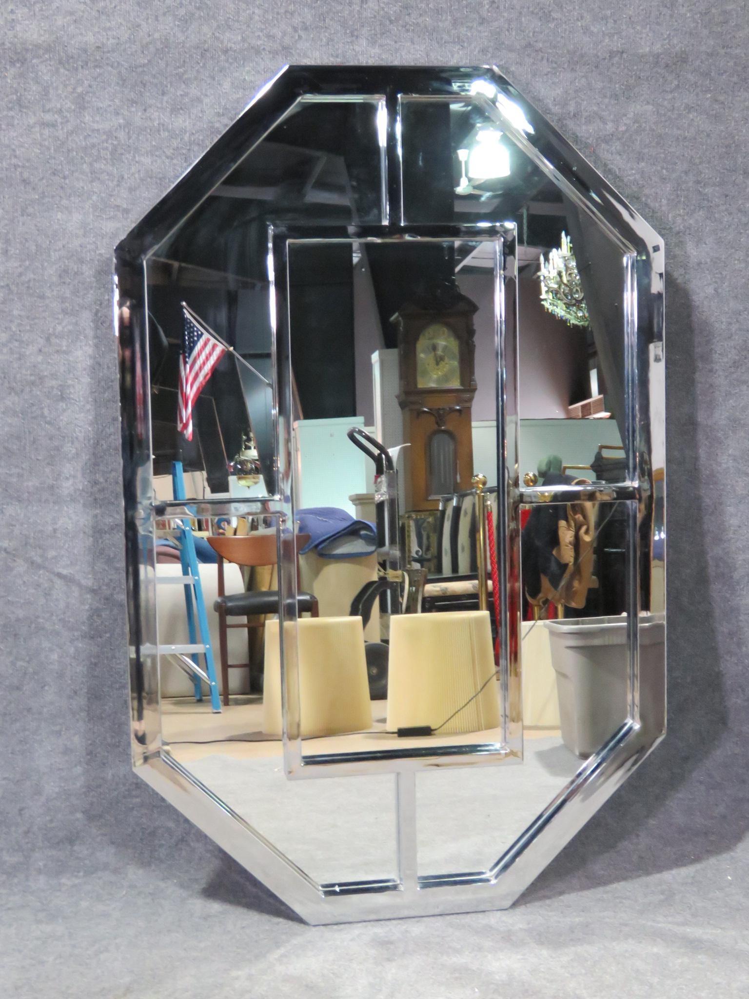 A dazzling Mid-Century Modern mirror in the style of Milo Baughman, this wall mirror combines glass and chrome for an impressive effect. Please confirm item location with seller (NY/NJ).