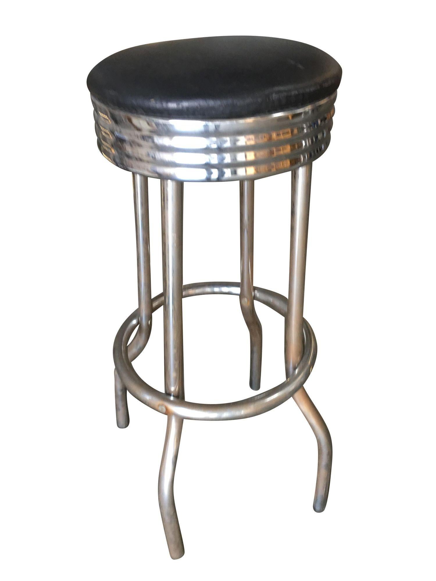 Original Mid Century 1950s Chrome Diner Bar Stool featuring an all-chromed steel design with a black vinyl seat. The stools have a nice patina to them with some signs of wear, and use, and very minor surface rust. A great look for your newly