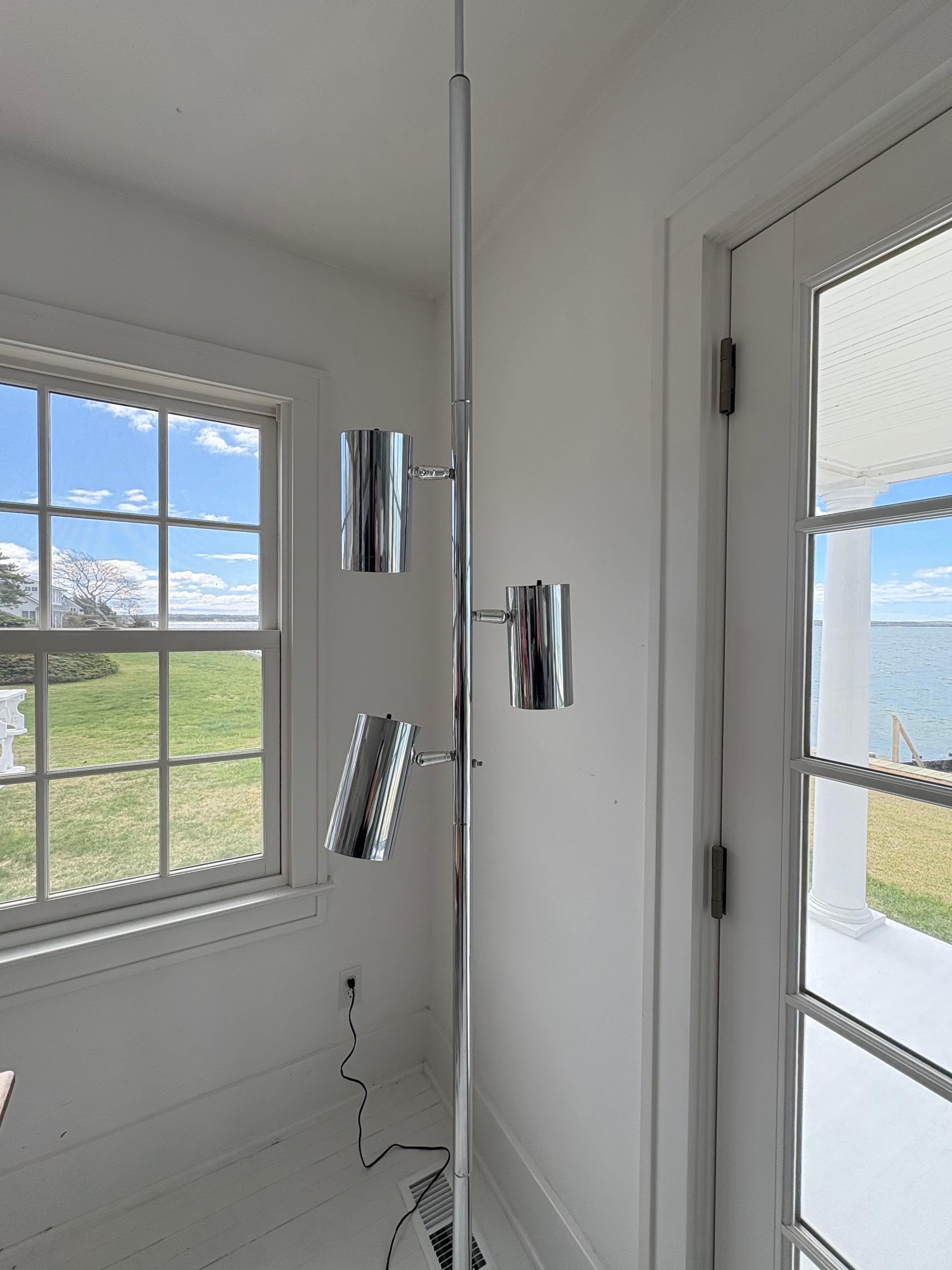 Very cool chrome tension pole floor lamp . The lamp has 3 cylindrical separate lights .Each light has its own switch for individual lighting or there is a switch that can be used for all three together to turn on or off. Lights pivot up and down and