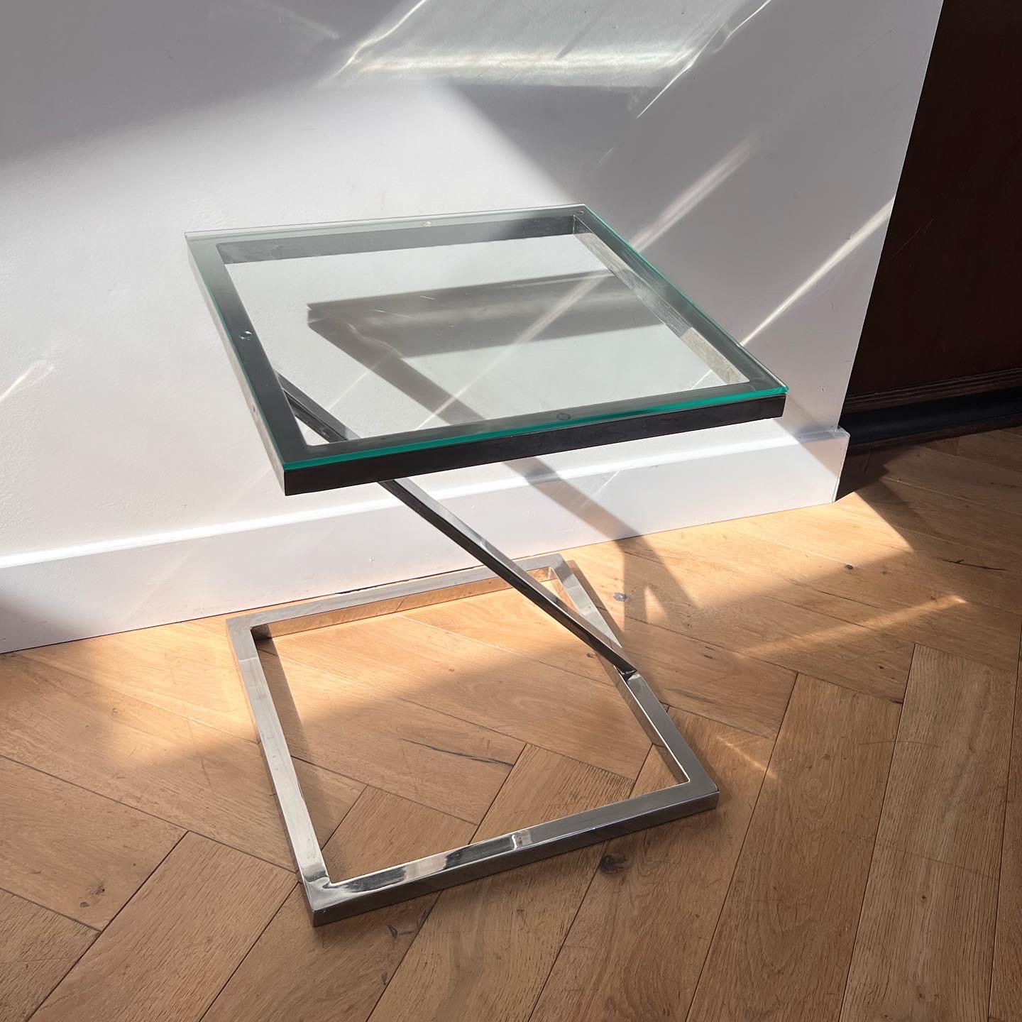 A Mid-Century Modern chrome side table with glass top, circa 1970. Featuring a very unique zig-zag shape, this table combines mcm, space-age, and postmodern sensibilities. Signs of wear are minimal but consistent with age and use. Pick up in central