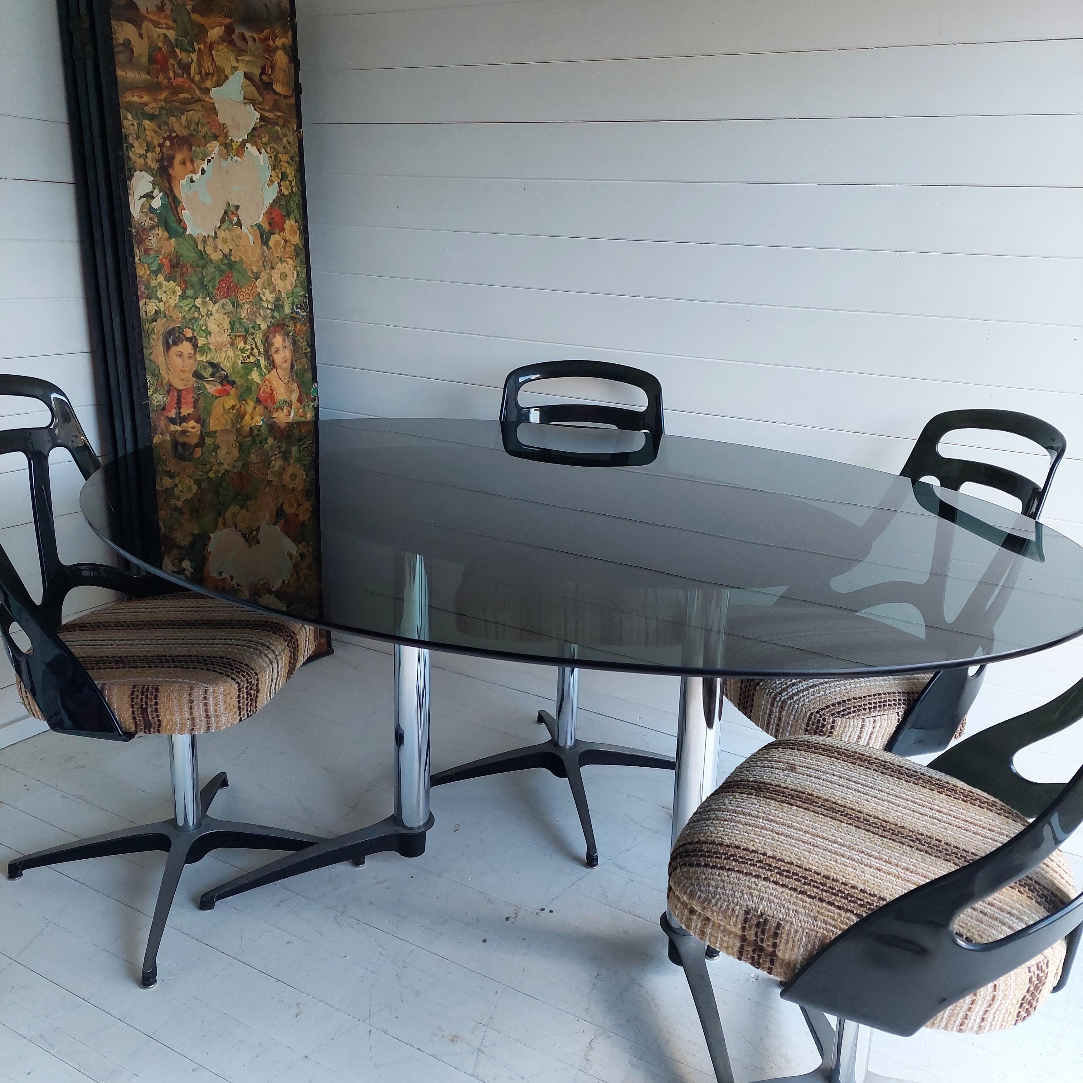 Retro Chromecraft USA Grafton Atomic Dining Table with 4 Chairs
A fantastic and extremely stylish 1972 dining room suite.

Comprising of a large oval dining room table with smoked glass top, and cast aluminium legs. 
This is accompanied by 4